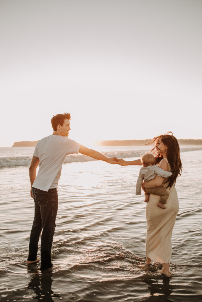 This dreamy beach family session was definitely one of my favorite sessions of last year! I actually met this family when they were expecting their first baby and documented their maternity which you can view here! Abi is such a kind, sweet and gentle woman and mother! She’s pregnant now with their second son. (Isn’t she absolutely glowing?) I’ll actually be documenting their wedding THIS YEAR as well and I’m so excited to capture all of those beautiful moments with them too! This family session was so much fun! Abi’s mom was there for the photos as well, which I love! They were all just so lovely and sweet. Sunset photos are so special because there’s always the chance that the moon can make an appearance later in your photos too. I love a family beach session at sunset. It’s a CLASSIC and a favorite! Head on over to Pinterest to save a couple if you like, love or found some inspiration in these! I hope you did. Let me know what you think!