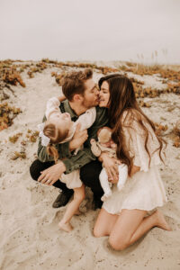 warm family beach photo shoot couples session on beach golden glow morning San Diego beach photographer