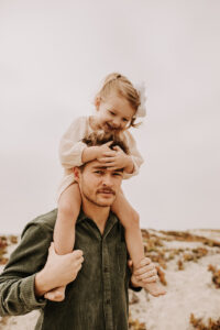 warm family beach photo shoot couples session on beach golden glow morning San Diego beach photographer