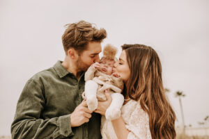 warm family beach photo shoot couples session on beach golden glow morning San Diego beach photographer