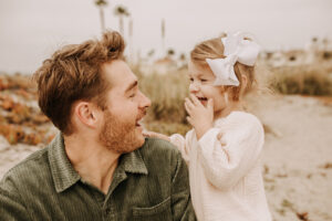 warm family beach photo shoot couples session on beach golden glow morning San Diego beach photographer