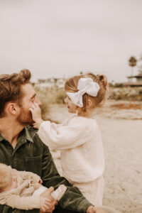 warm family beach photo shoot couples session on beach golden glow morning San Diego beach photographer