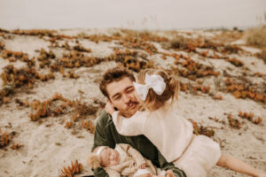 warm family beach photo shoot couples session on beach golden glow morning San Diego beach photographer