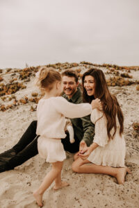 warm family beach photo shoot couples session on beach golden glow morning San Diego beach photographer