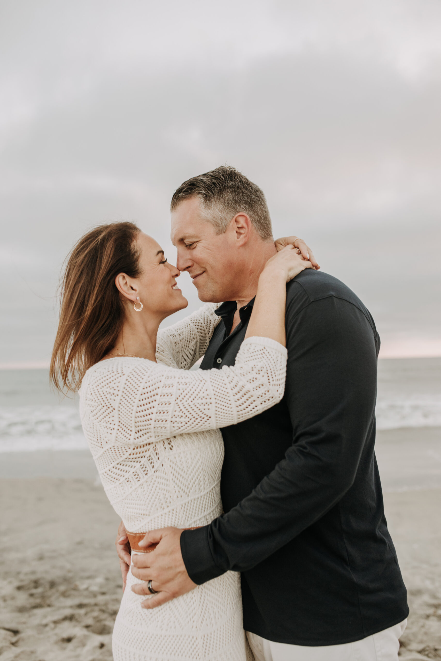 cool toned family photoshoot beach photos family photos on the beach cloudy vibes San Diego family photographer lifestyle photographer beach photoshoot inspo