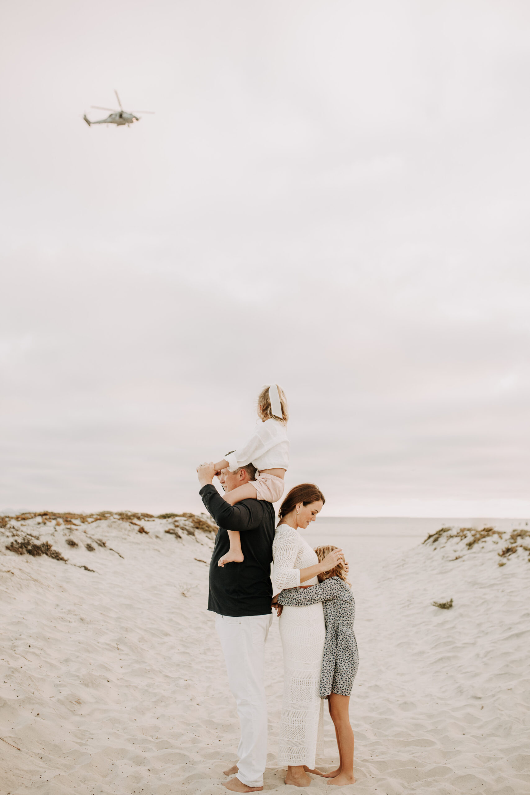 cool toned family photoshoot beach photos family photos on the beach cloudy vibes San Diego family photographer lifestyle photographer beach photoshoot inspo