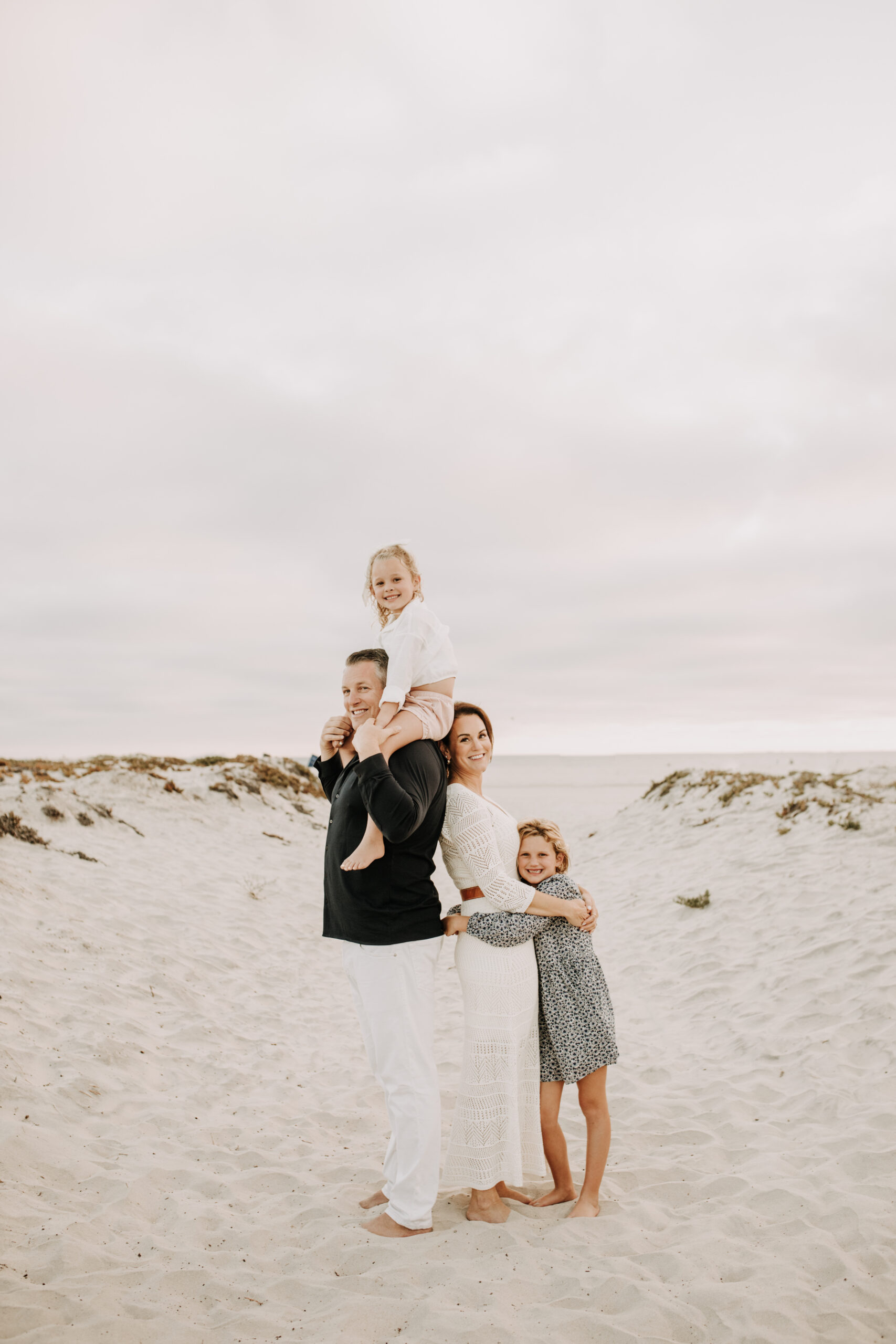 cool toned family photoshoot beach photos family photos on the beach cloudy vibes San Diego family photographer lifestyle photographer beach photoshoot inspo