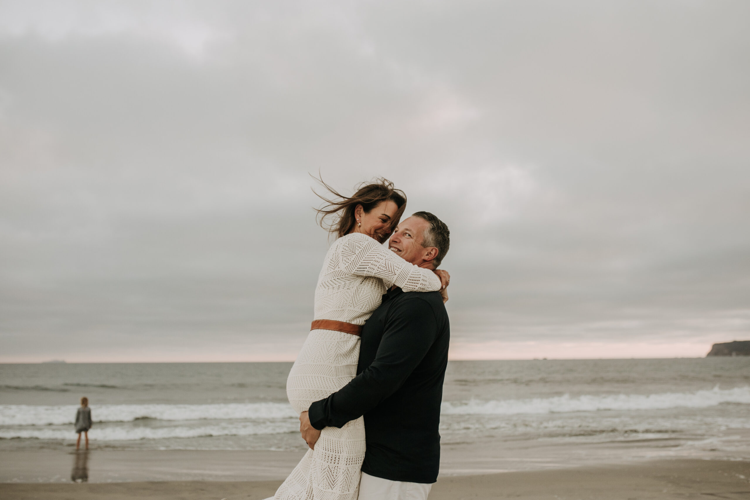 cool toned family photoshoot beach photos family photos on the beach cloudy vibes San Diego family photographer lifestyle photographer beach photoshoot inspo