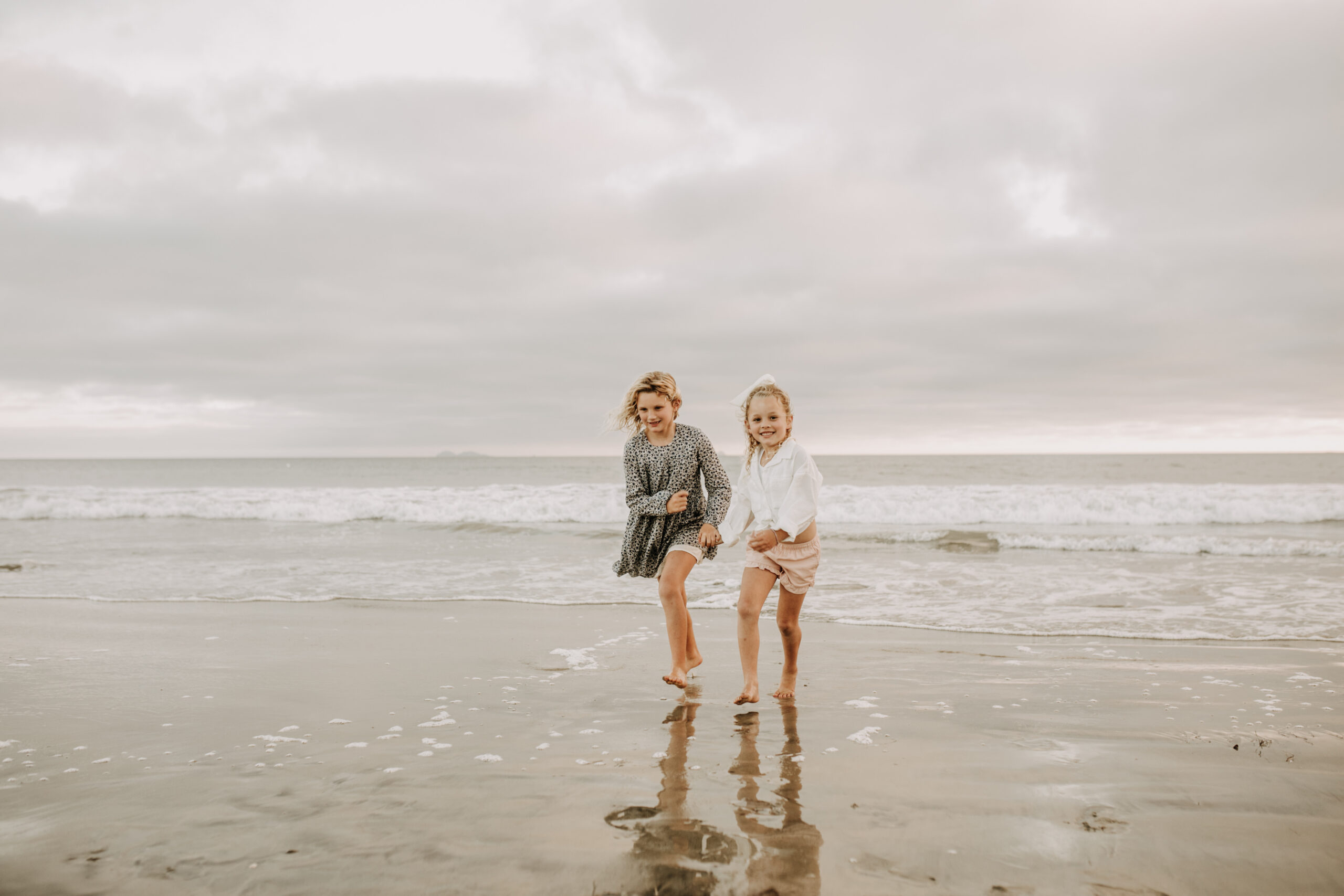 cool toned family photoshoot beach photos family photos on the beach cloudy vibes San Diego family photographer lifestyle photographer beach photoshoot inspo