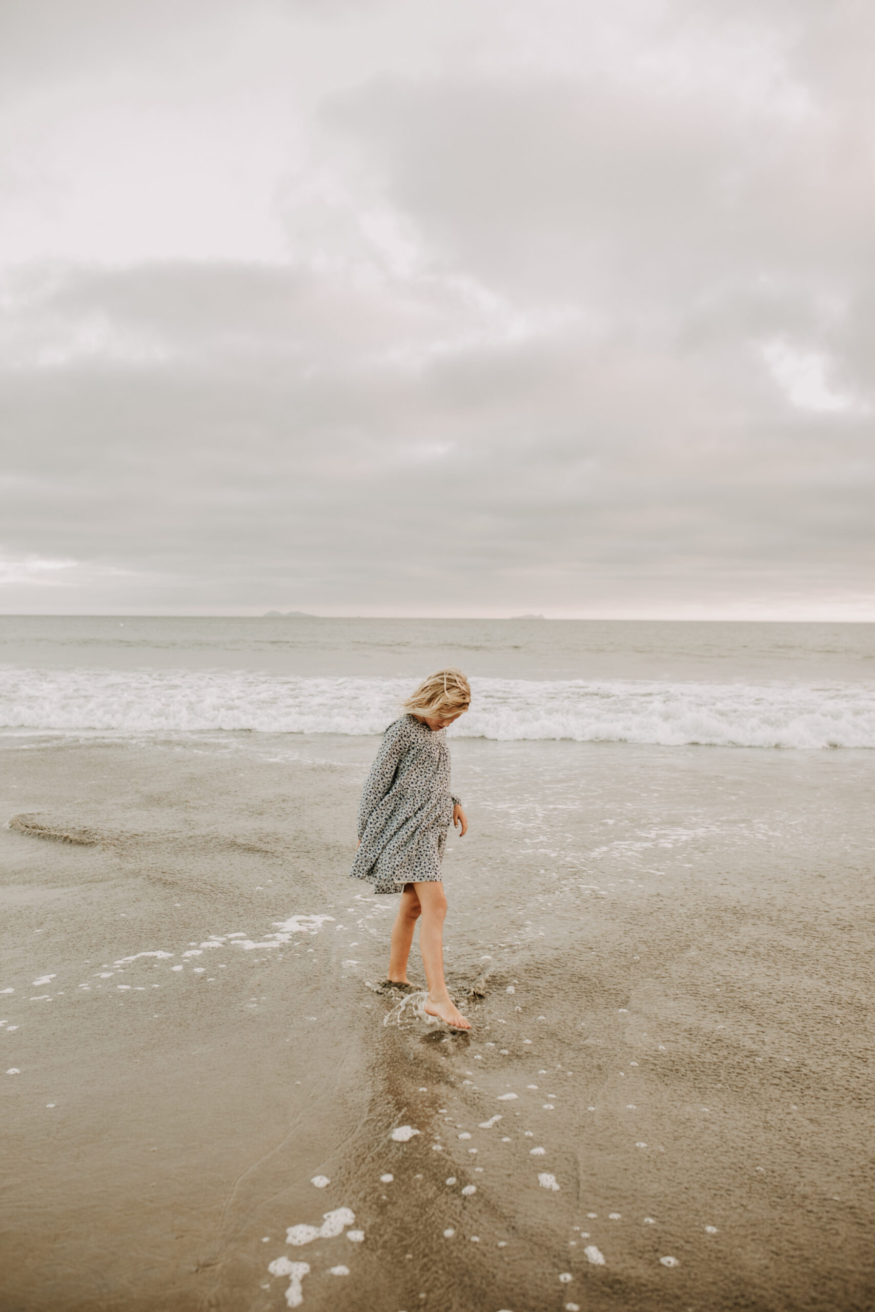 cool toned family photoshoot beach photos family photos on the beach cloudy vibes San Diego family photographer lifestyle photographer beach photoshoot inspo