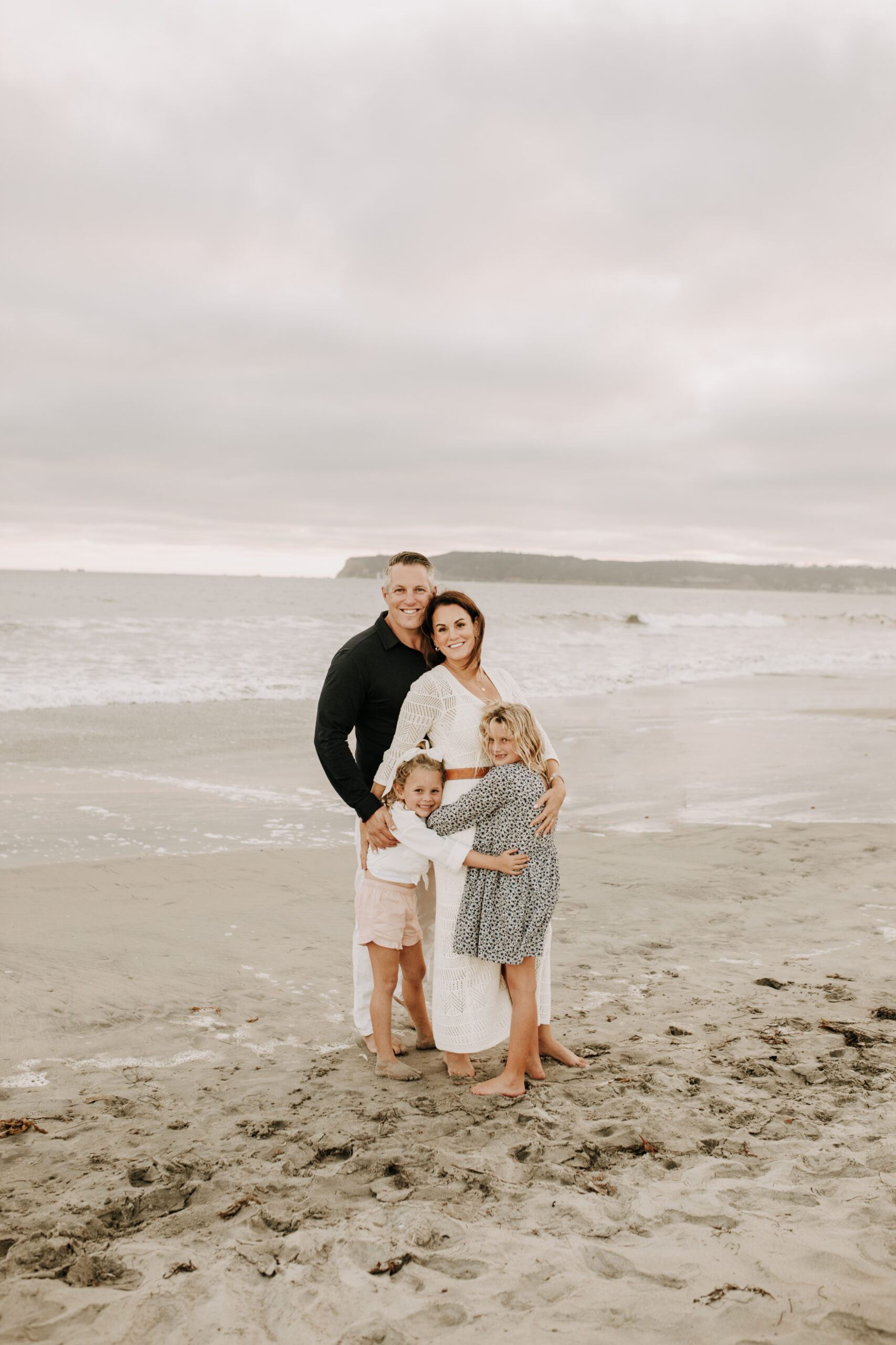 cool toned family photoshoot beach photos family photos on the beach cloudy vibes San Diego family photographer lifestyle photographer beach photoshoot inspo