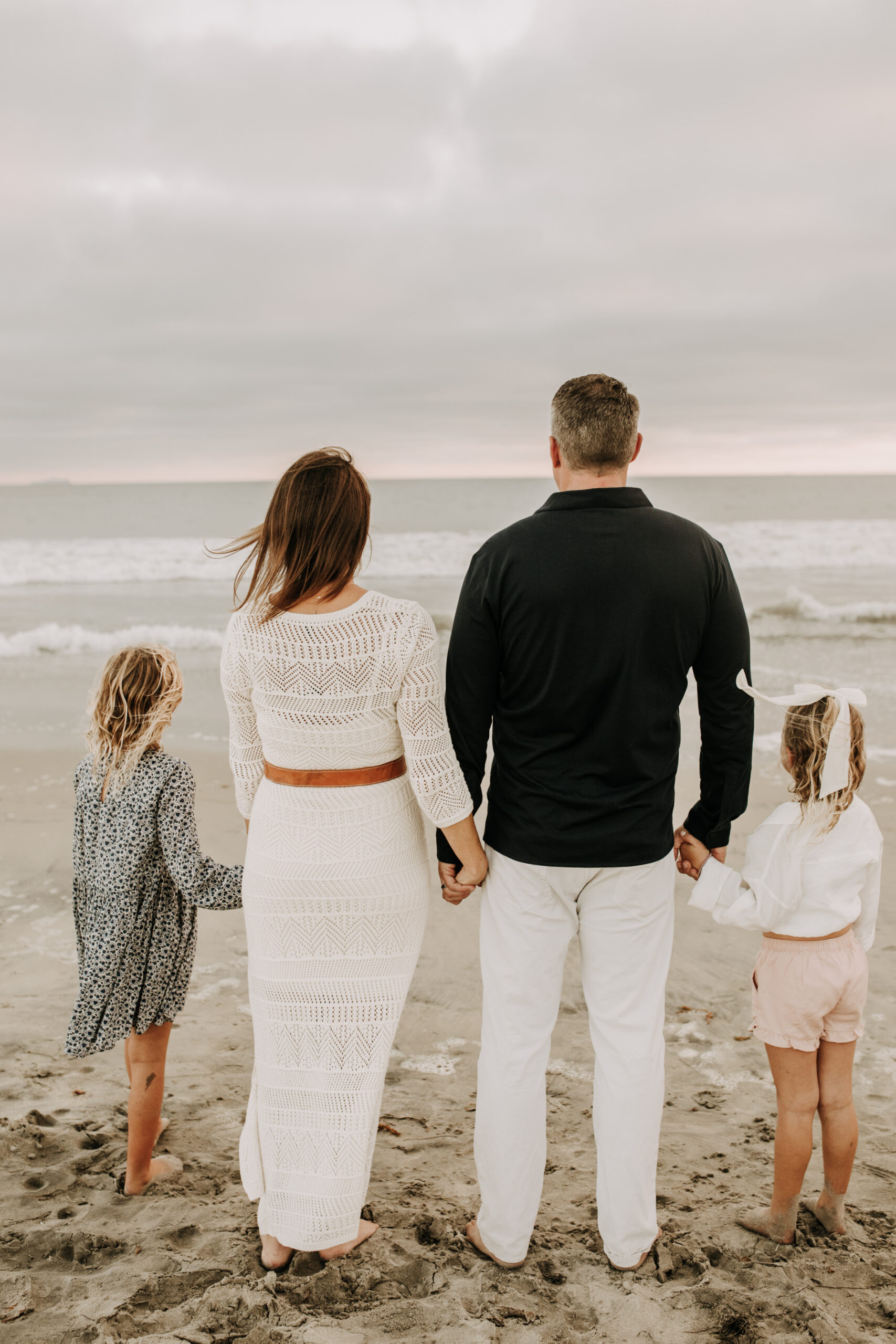 cool toned family photoshoot beach photos family photos on the beach cloudy vibes San Diego family photographer lifestyle photographer beach photoshoot inspo