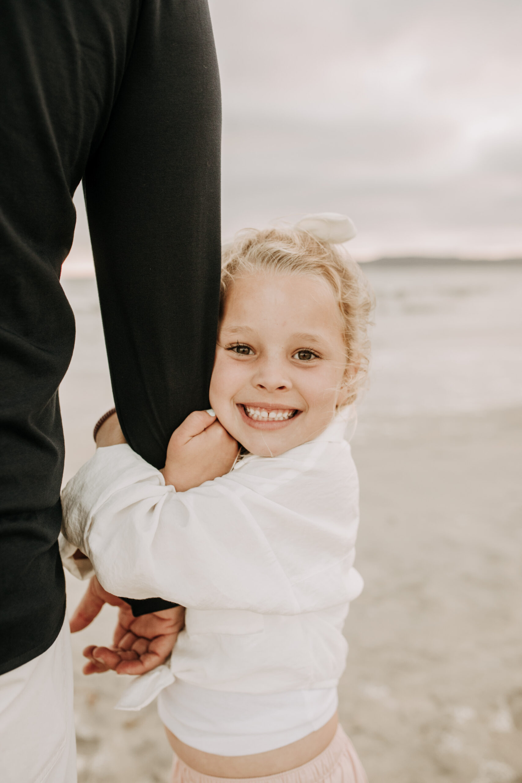 cool toned family photoshoot beach photos family photos on the beach cloudy vibes San Diego family photographer lifestyle photographer beach photoshoot inspo