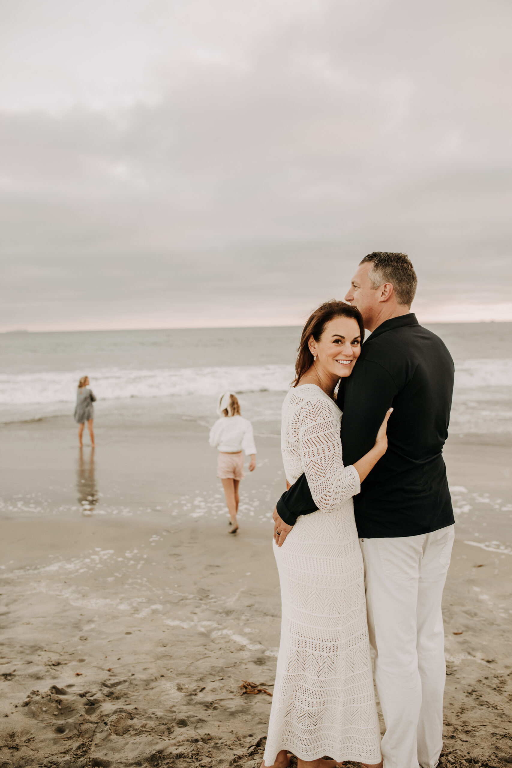 cool toned family photoshoot beach photos family photos on the beach cloudy vibes San Diego family photographer lifestyle photographer beach photoshoot inspo