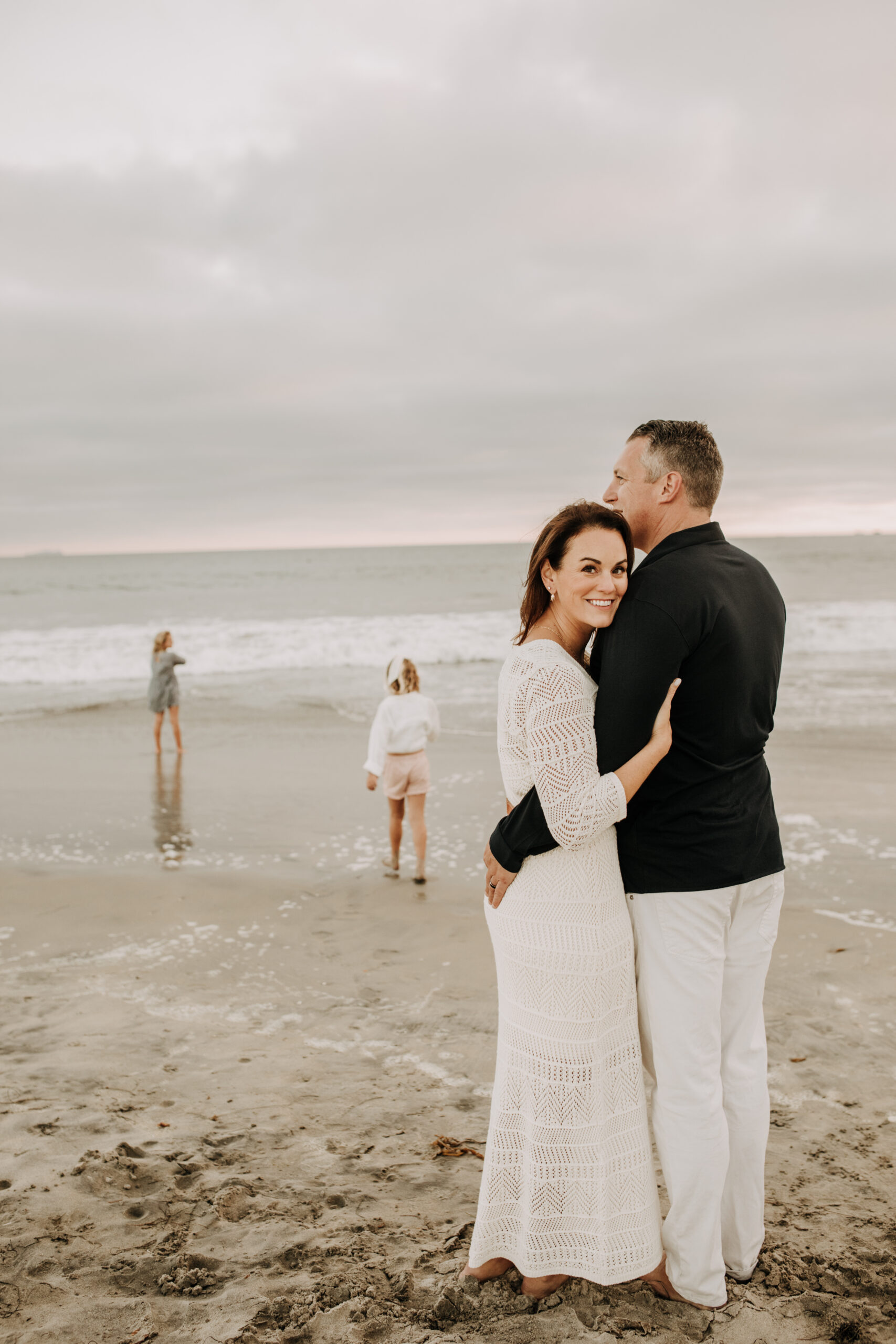 cool toned family photoshoot beach photos family photos on the beach cloudy vibes San Diego family photographer lifestyle photographer beach photoshoot inspo