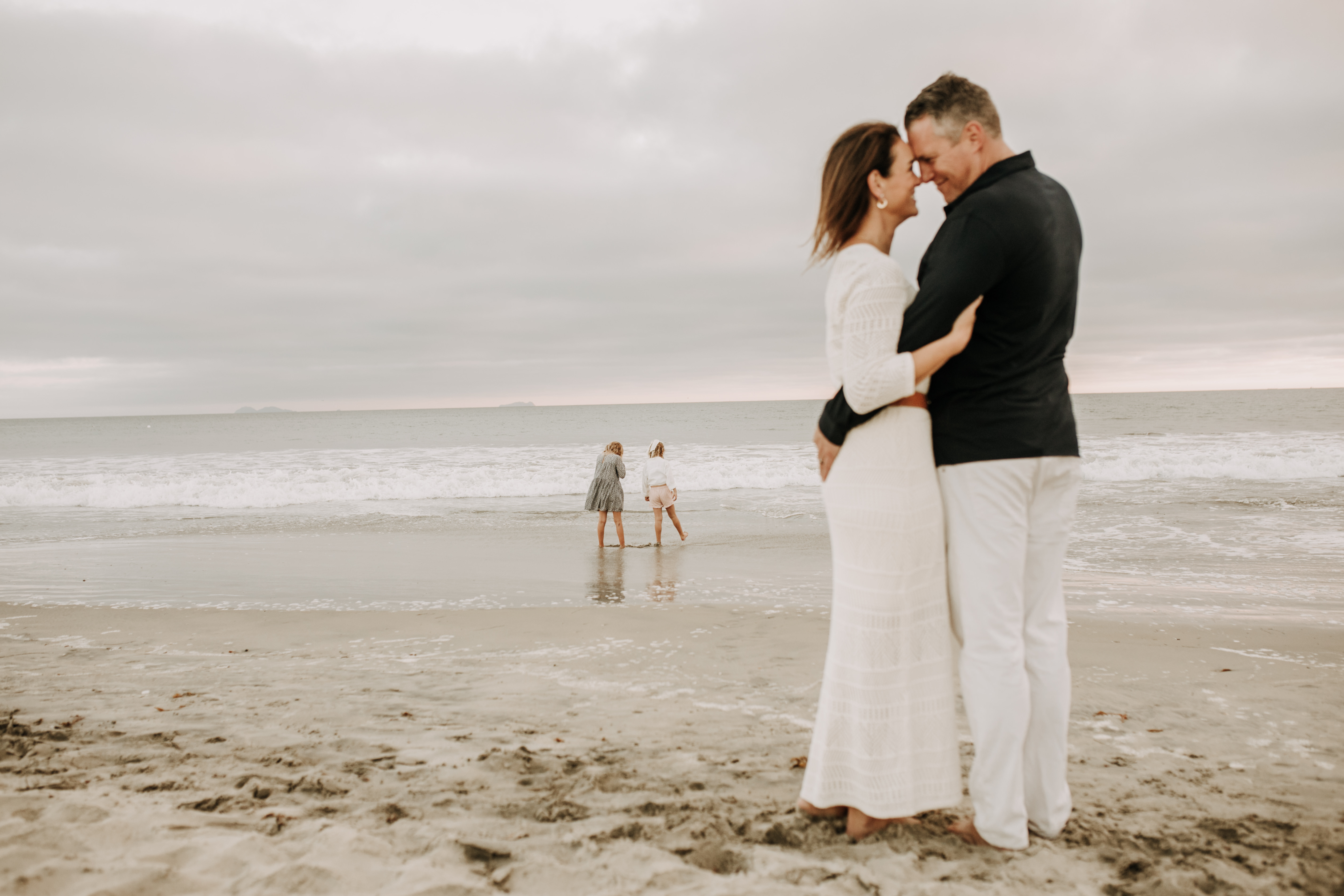 cool toned family photoshoot beach photos family photos on the beach cloudy vibes San Diego family photographer lifestyle photographer beach photoshoot inspo