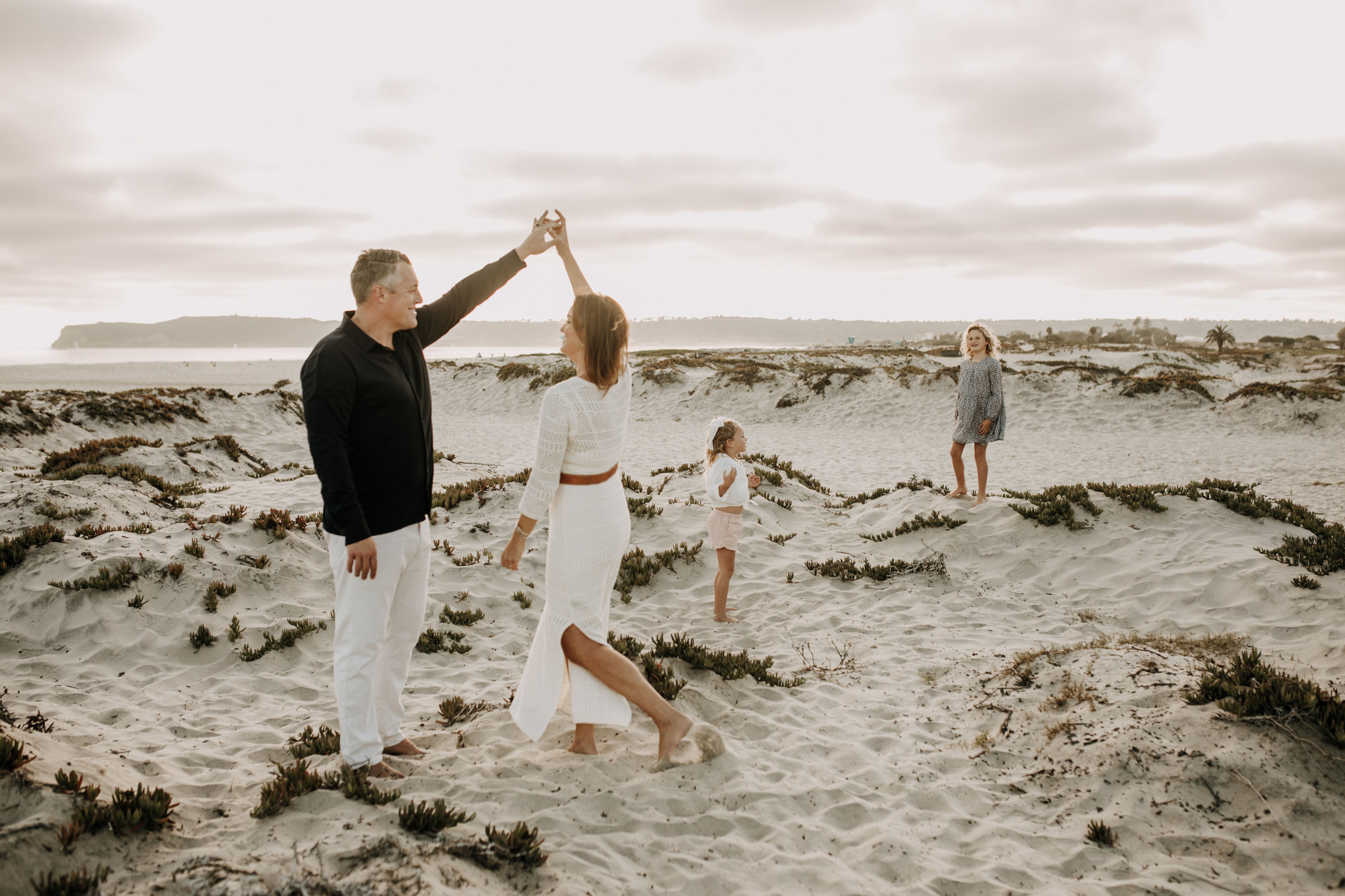 cool toned family photoshoot beach photos family photos on the beach cloudy vibes San Diego family photographer lifestyle photographer beach photoshoot inspo