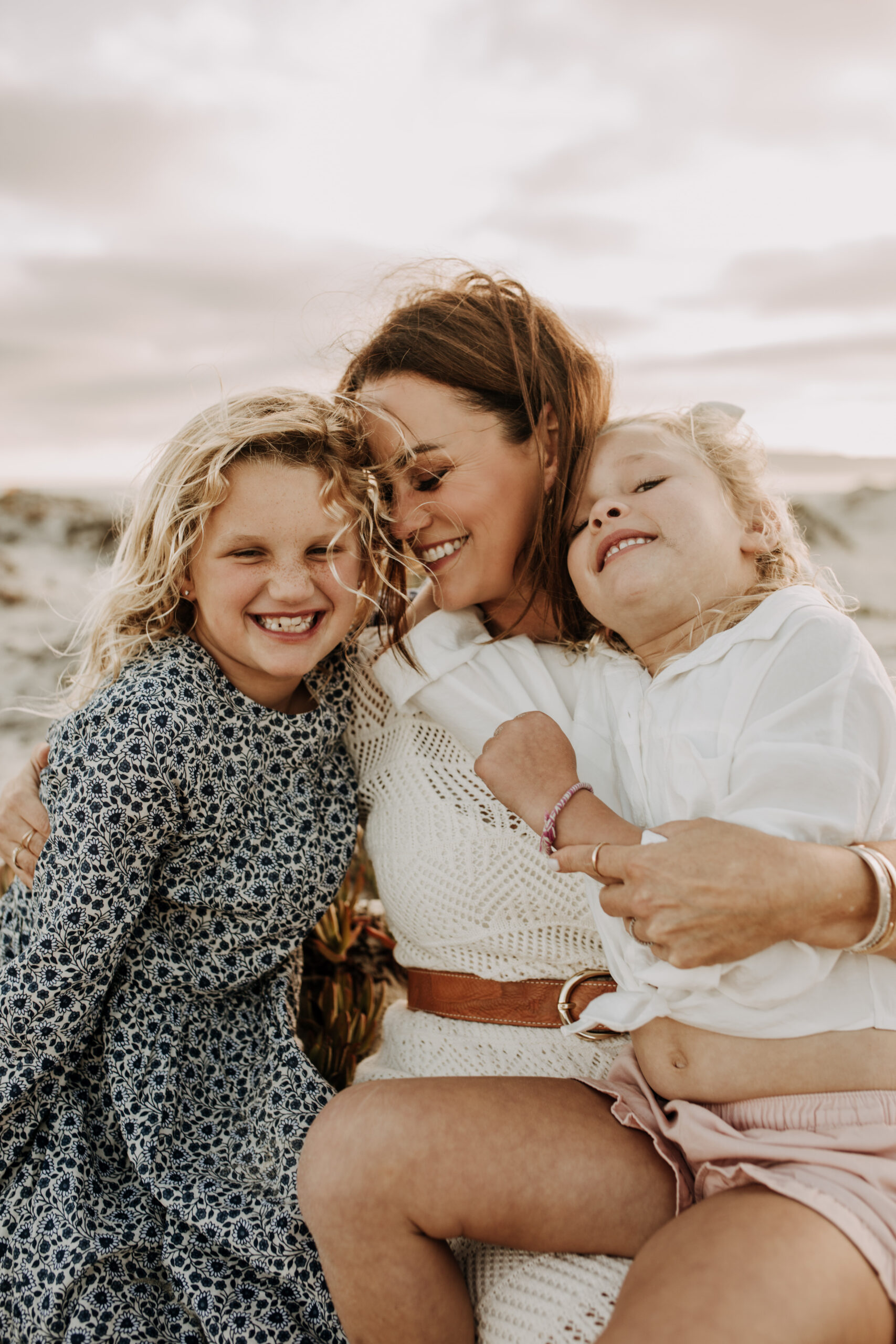 cool toned family photoshoot beach photos family photos on the beach cloudy vibes San Diego family photographer lifestyle photographer beach photoshoot inspo