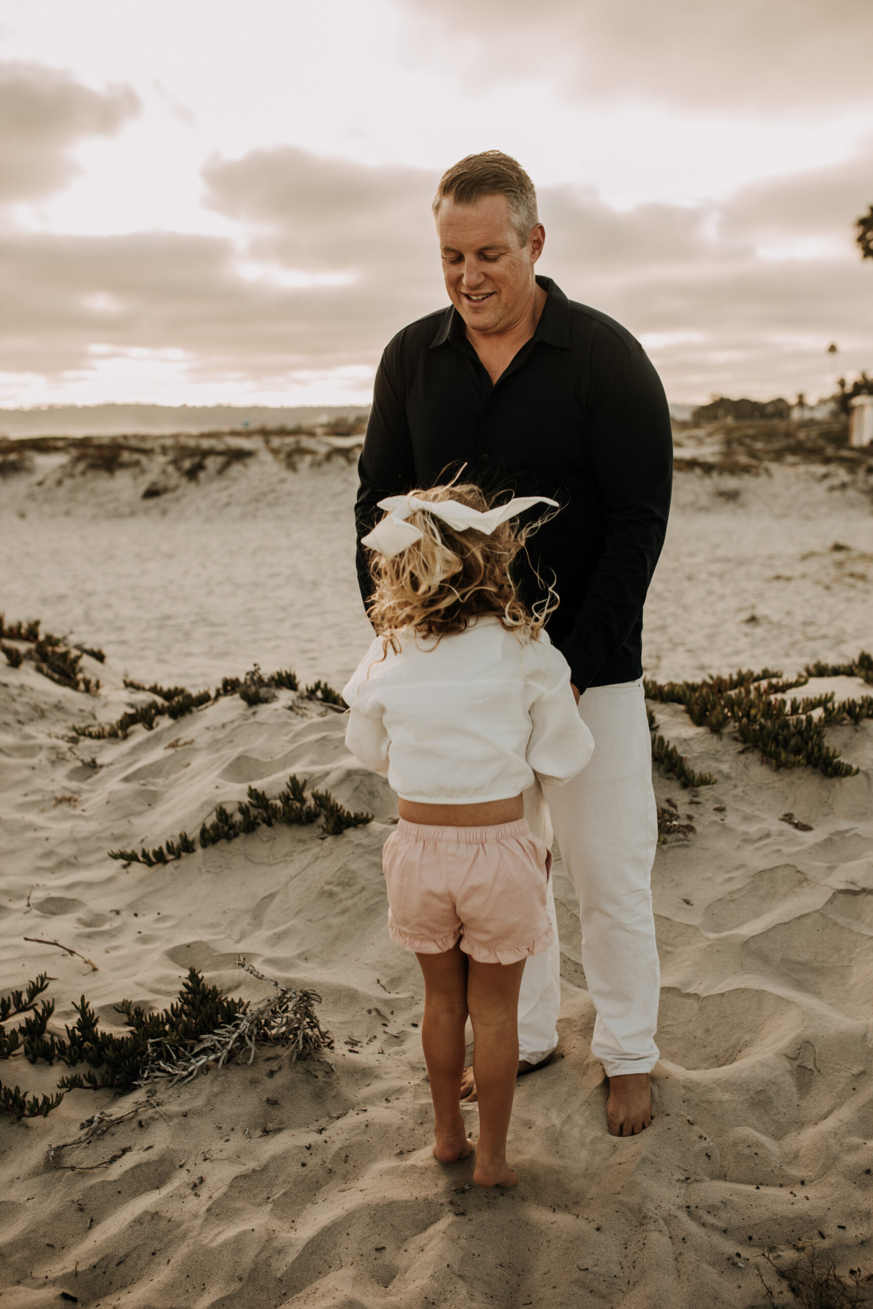 cool toned family photoshoot beach photos family photos on the beach cloudy vibes San Diego family photographer lifestyle photographer beach photoshoot inspo