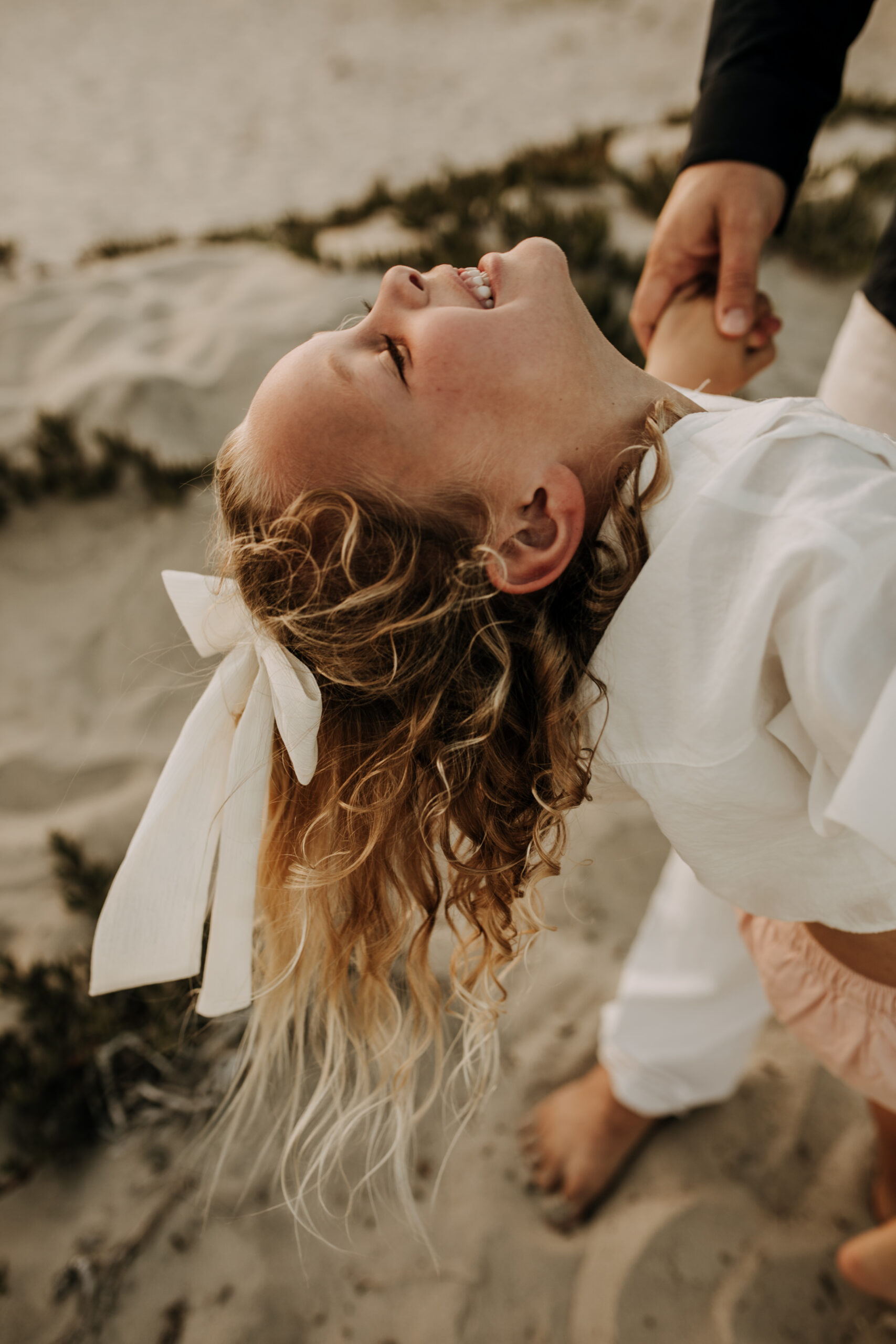 cool toned family photoshoot beach photos family photos on the beach cloudy vibes San Diego family photographer lifestyle photographer beach photoshoot inspo