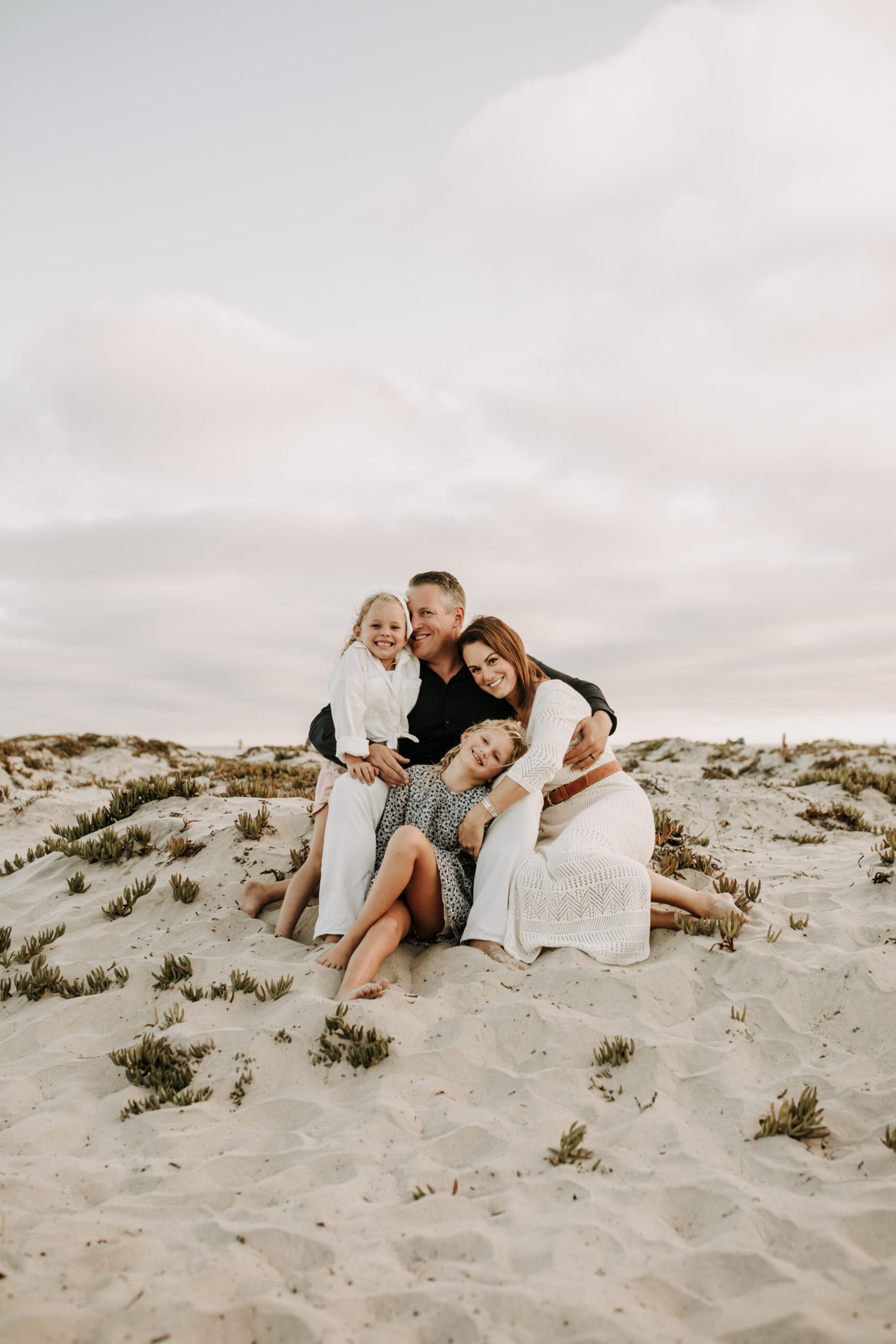 cool toned family photoshoot beach photos family photos on the beach cloudy vibes San Diego family photographer lifestyle photographer beach photoshoot inspo