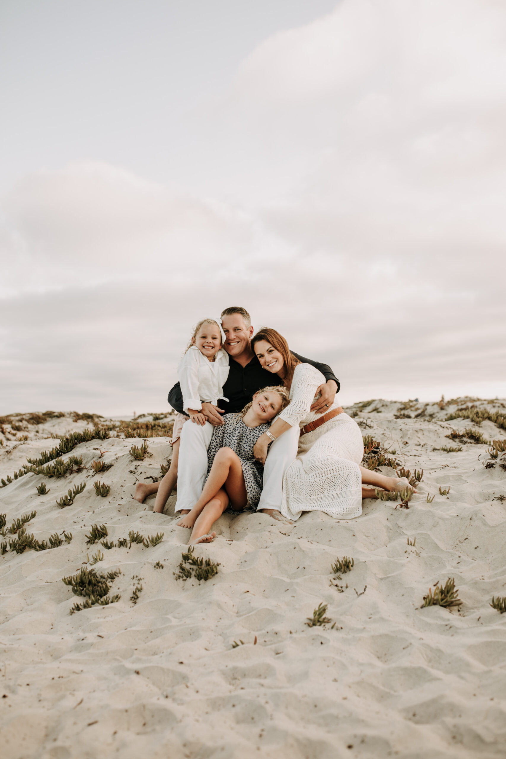 cool toned family photoshoot beach photos family photos on the beach cloudy vibes San Diego family photographer lifestyle photographer beach photoshoot inspo