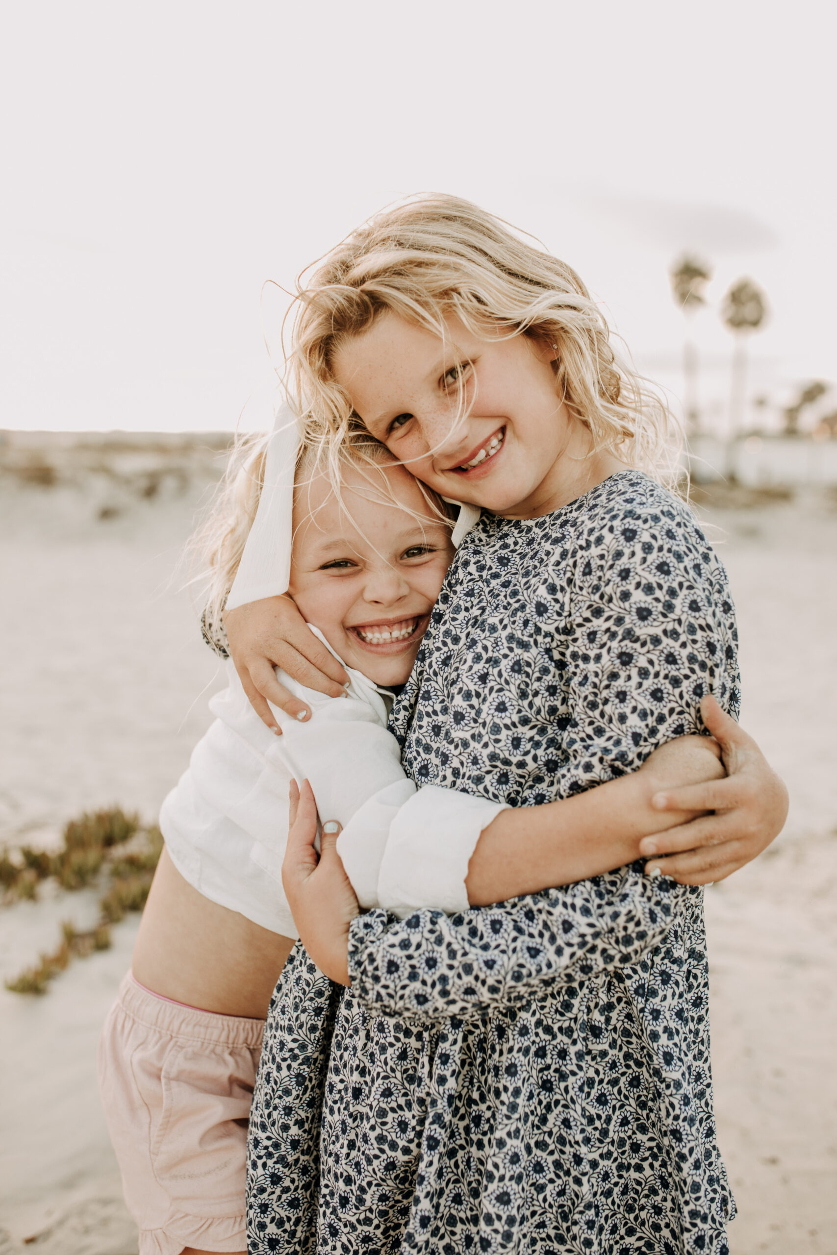 cool toned family photoshoot beach photos family photos on the beach cloudy vibes San Diego family photographer lifestyle photographer beach photoshoot inspo