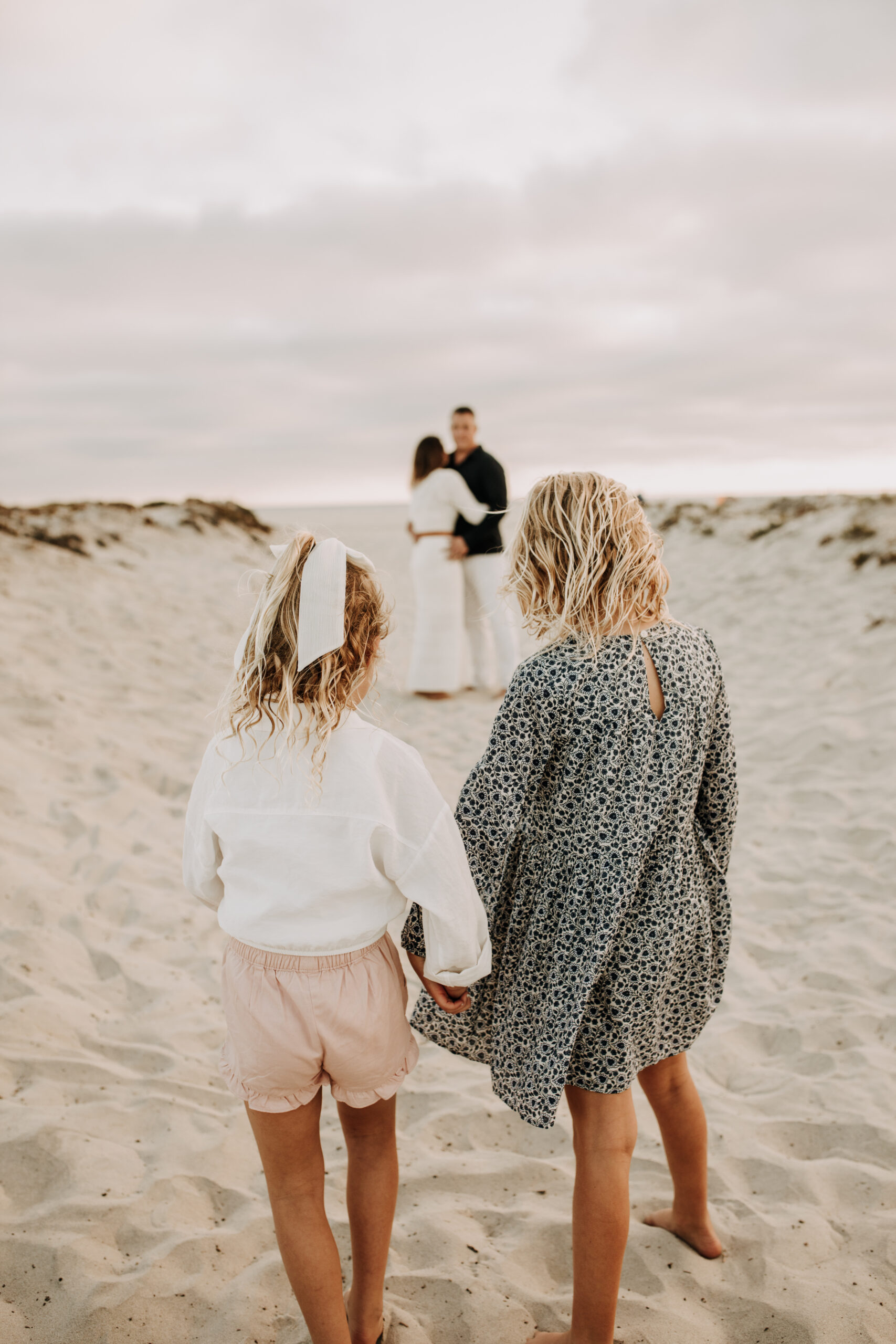 cool toned family photoshoot beach photos family photos on the beach cloudy vibes San Diego family photographer lifestyle photographer beach photoshoot inspo