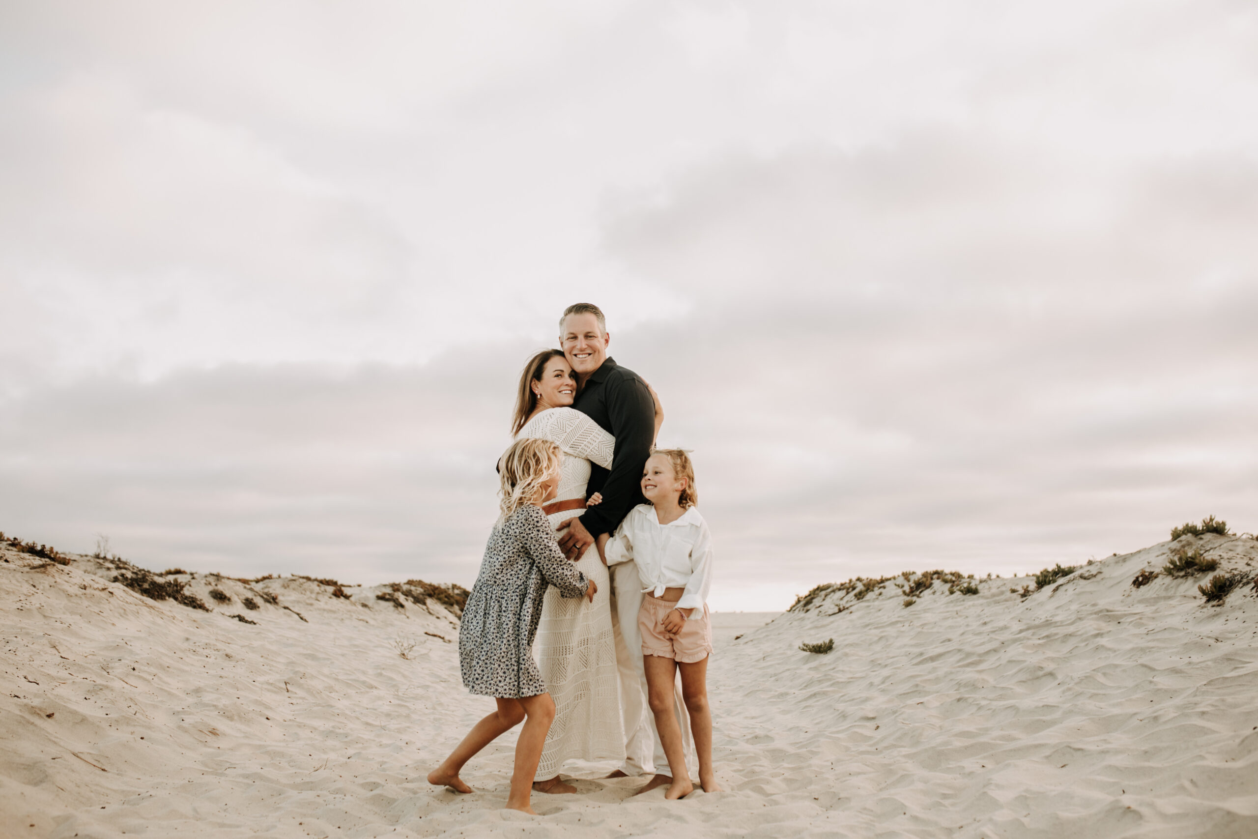 cool toned family photoshoot beach photos family photos on the beach cloudy vibes San Diego family photographer lifestyle photographer beach photoshoot inspo