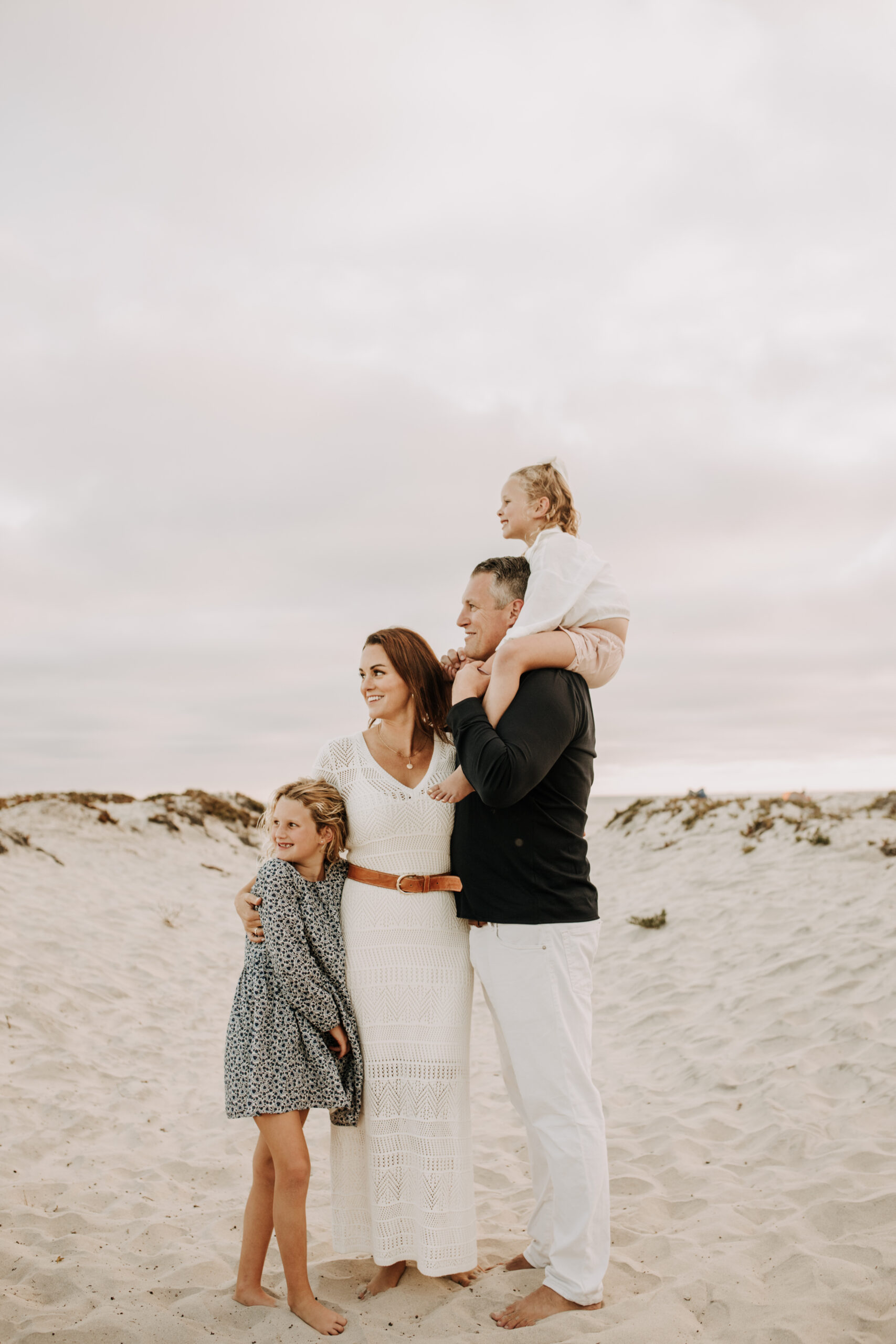 cool toned family photoshoot beach photos family photos on the beach cloudy vibes San Diego family photographer lifestyle photographer beach photoshoot inspo