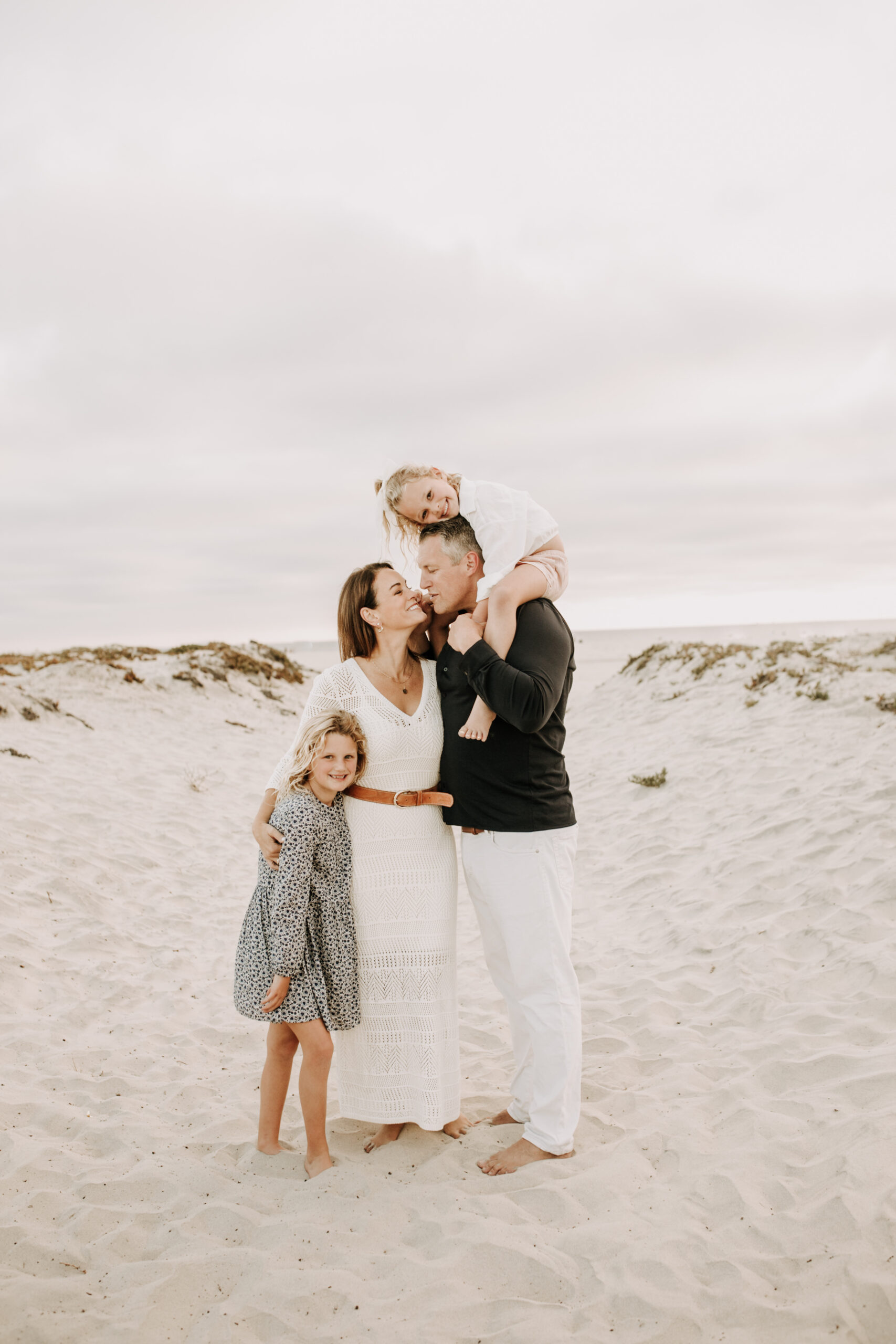 cool toned family photoshoot beach photos family photos on the beach cloudy vibes San Diego family photographer lifestyle photographer beach photoshoot inspo