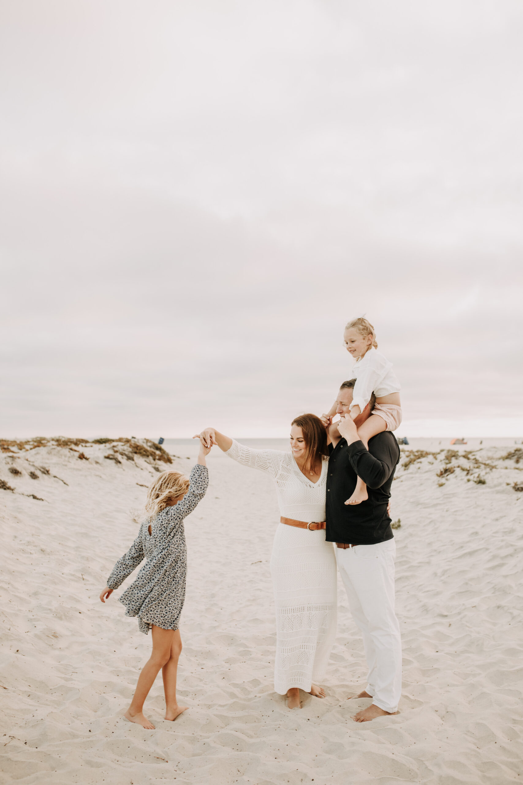 cool toned family photoshoot beach photos family photos on the beach cloudy vibes San Diego family photographer lifestyle photographer beach photoshoot inspo