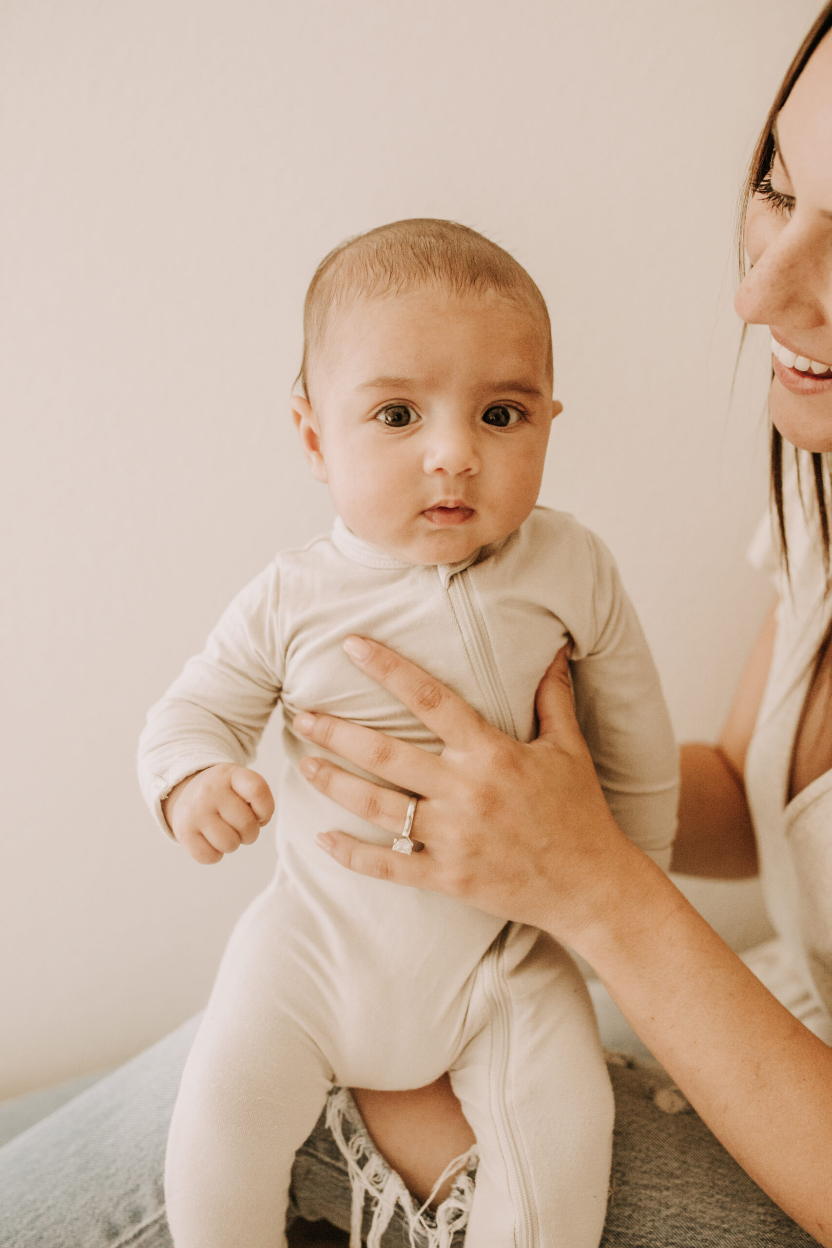 warm toned tan beige in home newborn baby photos family photos newborn baby new mom and dad San Diego family photographer Sabrina kinsella sabrinalynnphoto