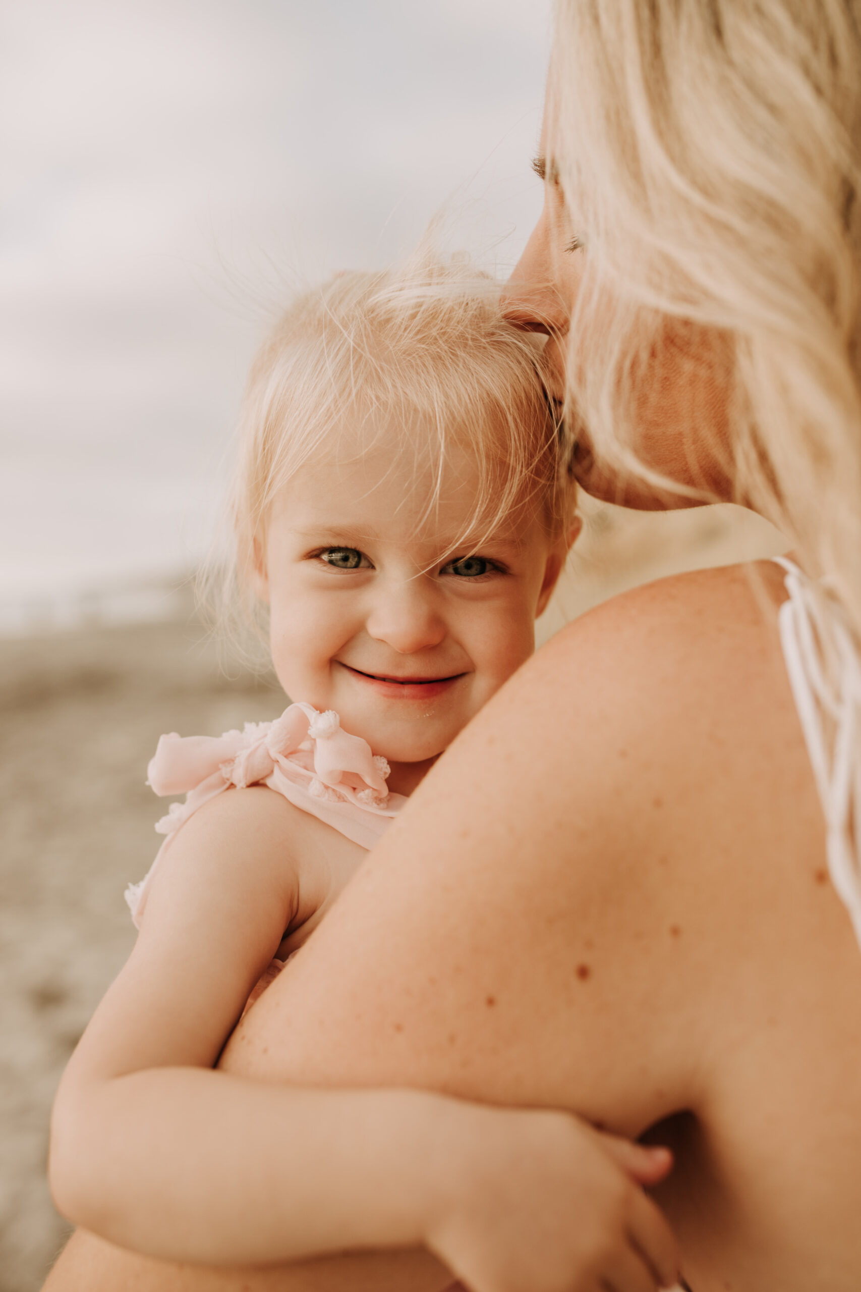 family photos on the beach sunset beach family dad mom baby water golden hour San Diego beach family photos San Diego family photographer