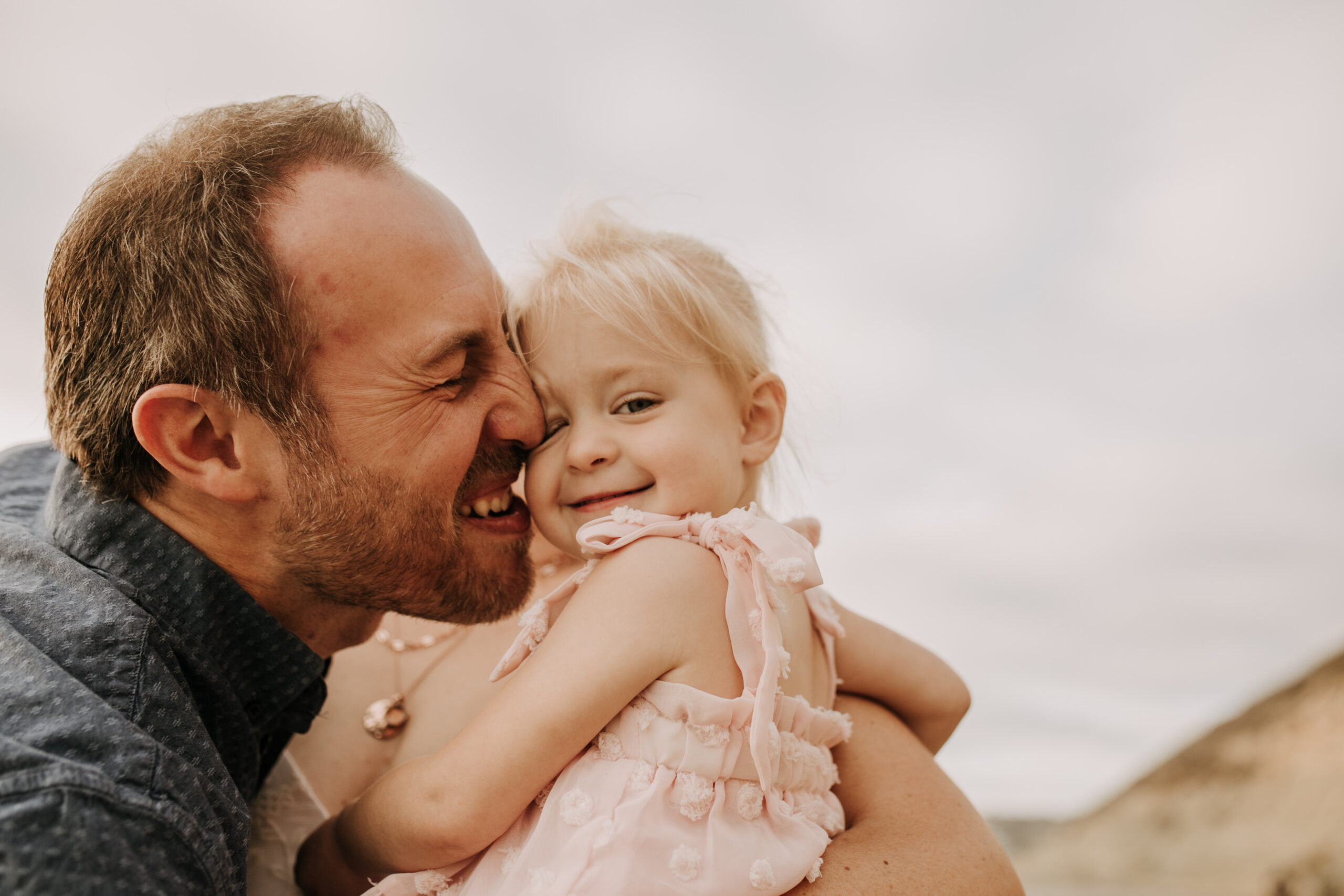 family photos on the beach sunset beach family dad mom baby water golden hour San Diego beach family photos San Diego family photographer