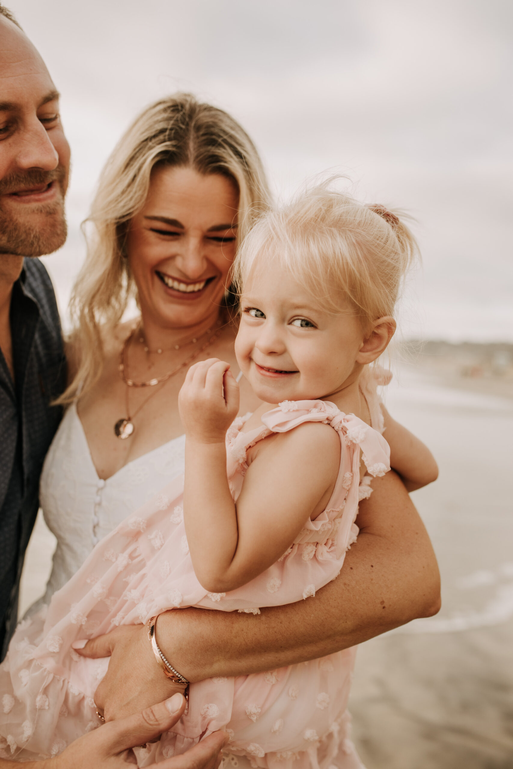 family photos on the beach sunset beach family dad mom baby water golden hour San Diego beach family photos San Diego family photographer