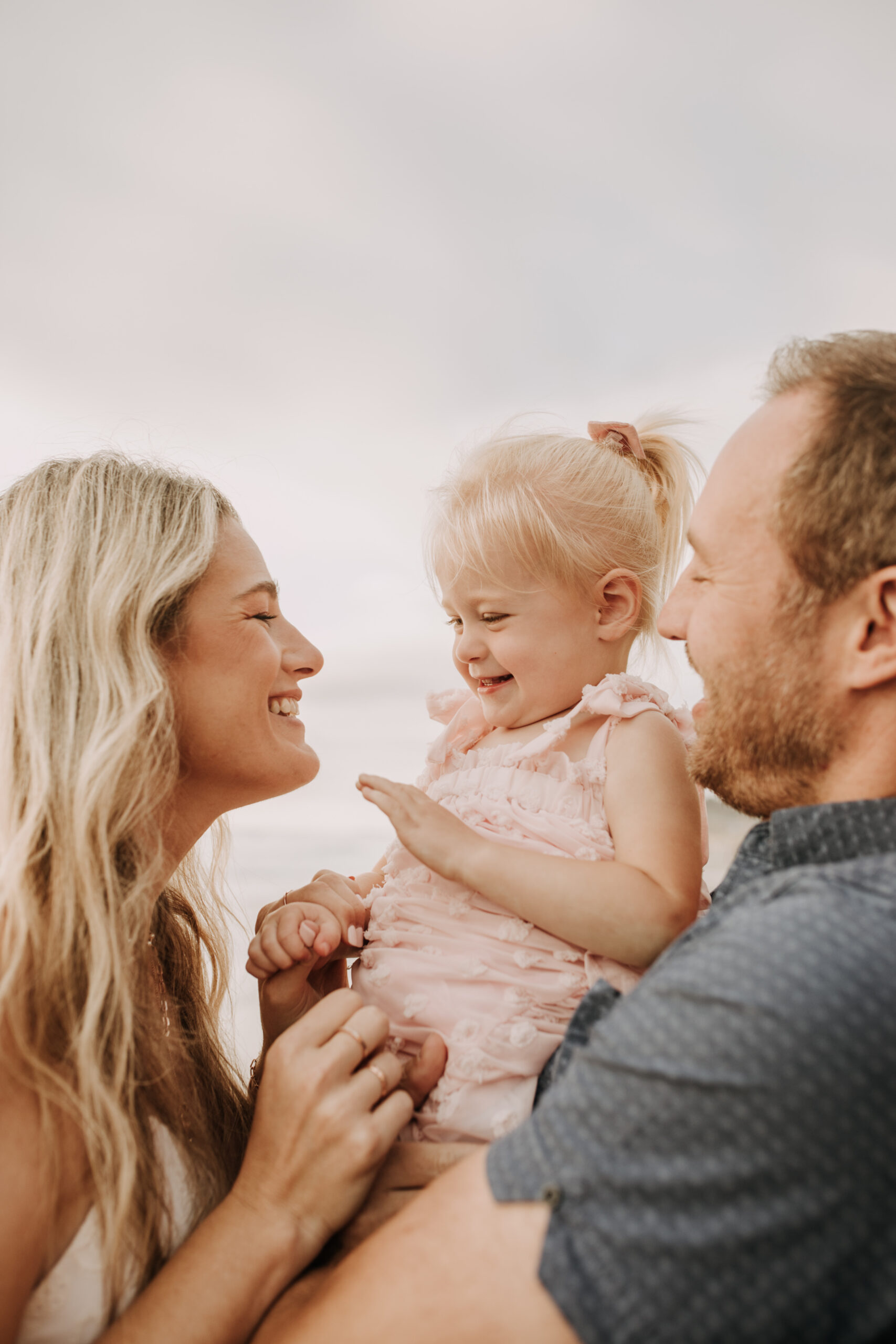 family photos on the beach sunset beach family dad mom baby water golden hour San Diego beach family photos San Diego family photographer