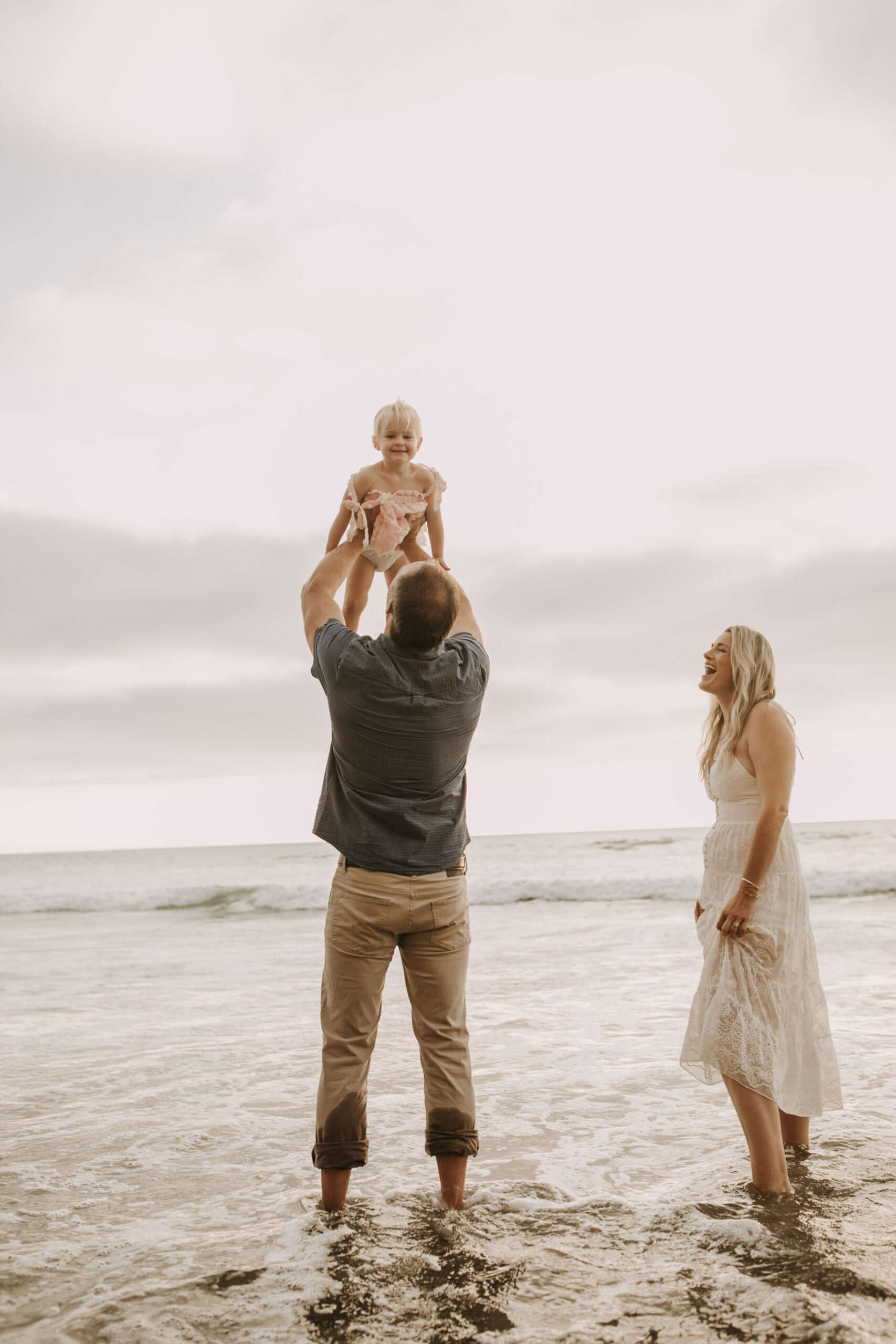 family photos on the beach sunset beach family dad mom baby water golden hour San Diego beach family photos San Diego family photographer