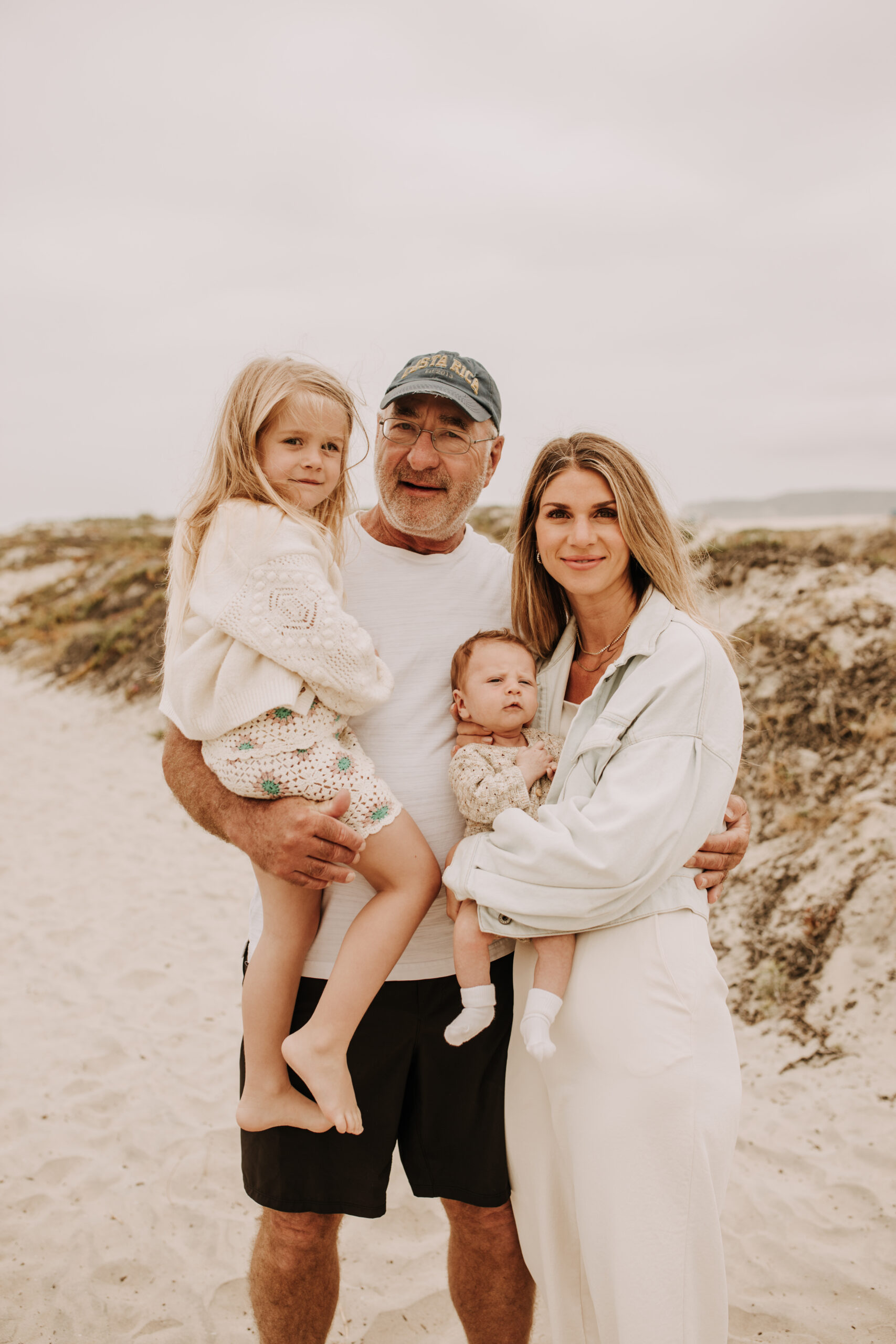 warm toned neutral color outdoor family photos beach day family photos newborn photos infant family cloudy day san digo family photographer Sabrina Kinsella