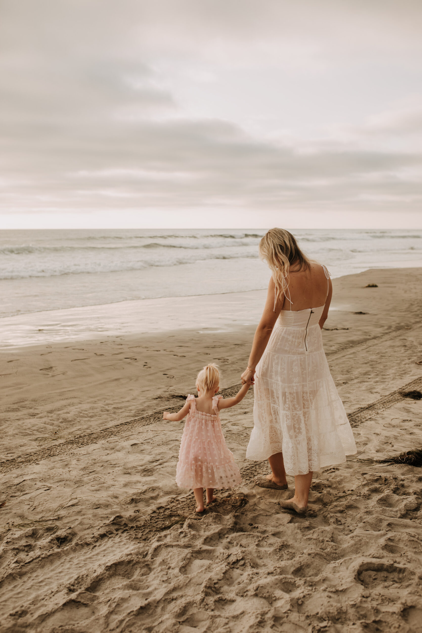 family photos on the beach sunset beach family dad mom baby water golden hour San Diego beach family photos San Diego family photographer