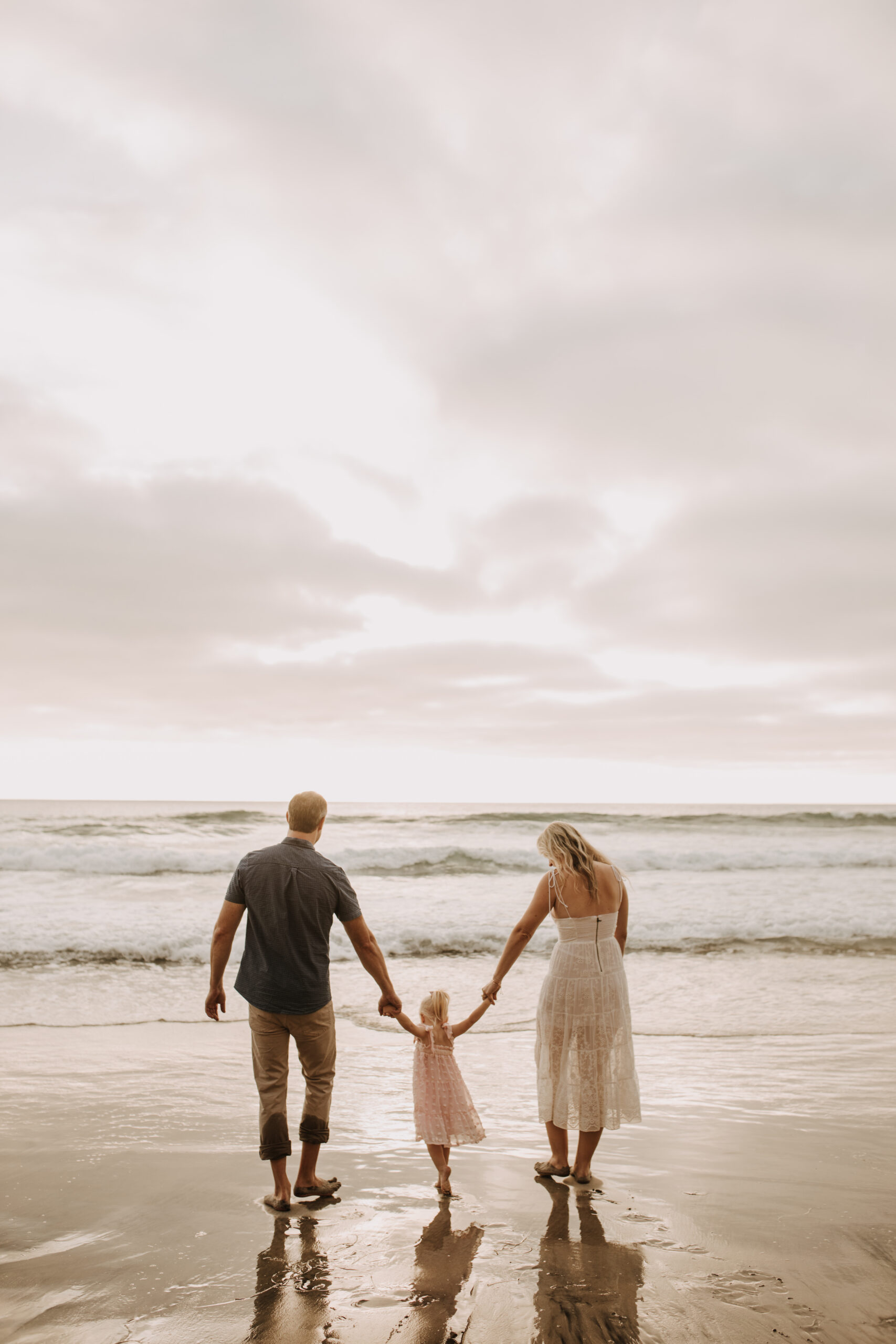 family photos on the beach sunset beach family dad mom baby water golden hour San Diego beach family photos San Diego family photographer