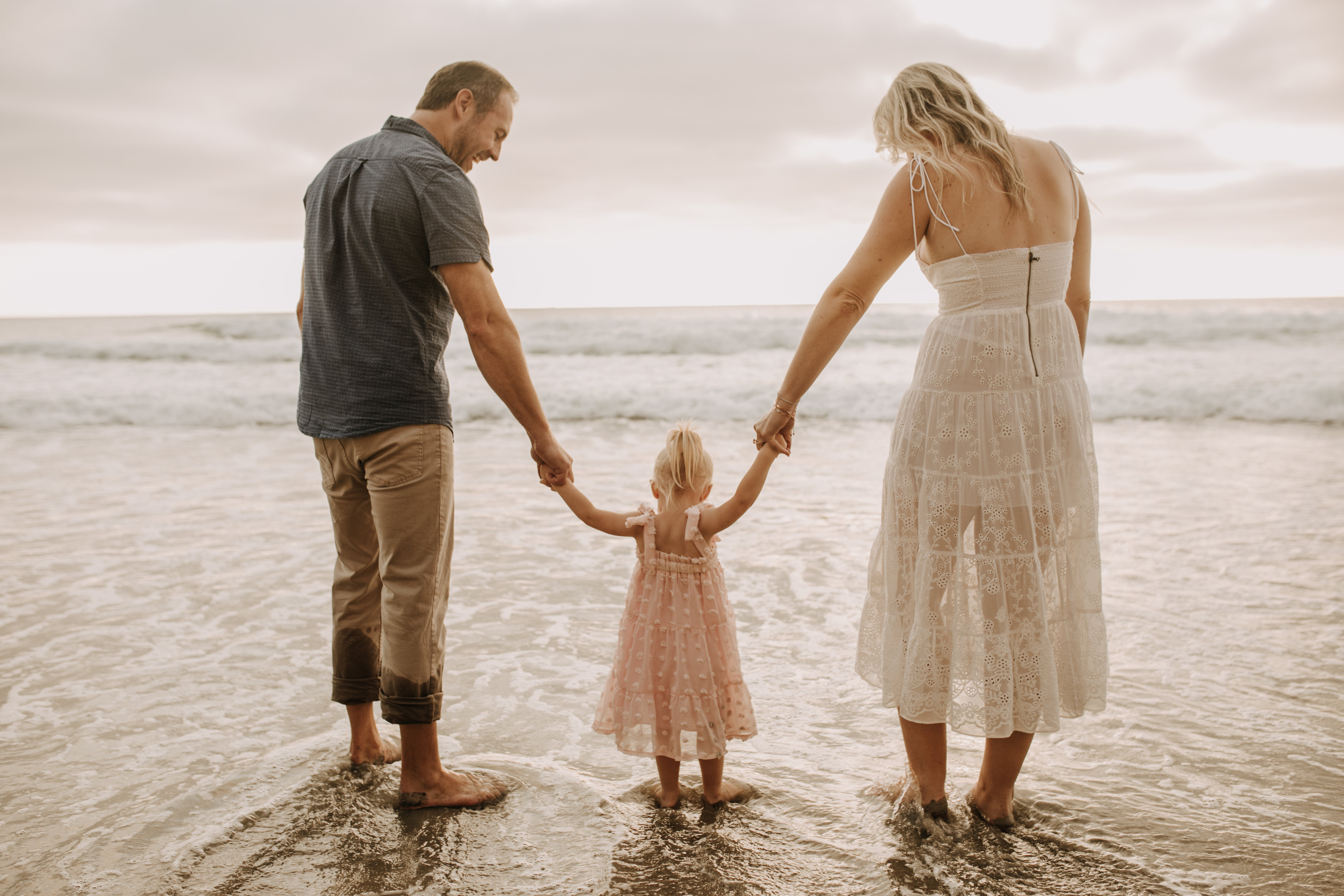 family photos on the beach sunset beach family dad mom baby water golden hour San Diego beach family photos San Diego family photographer