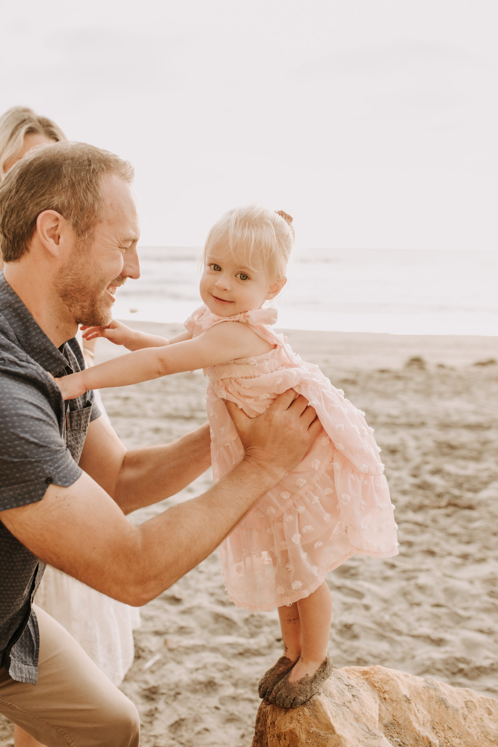 family photos on the beach sunset beach family dad mom baby water golden hour San Diego beach family photos San Diego family photographer