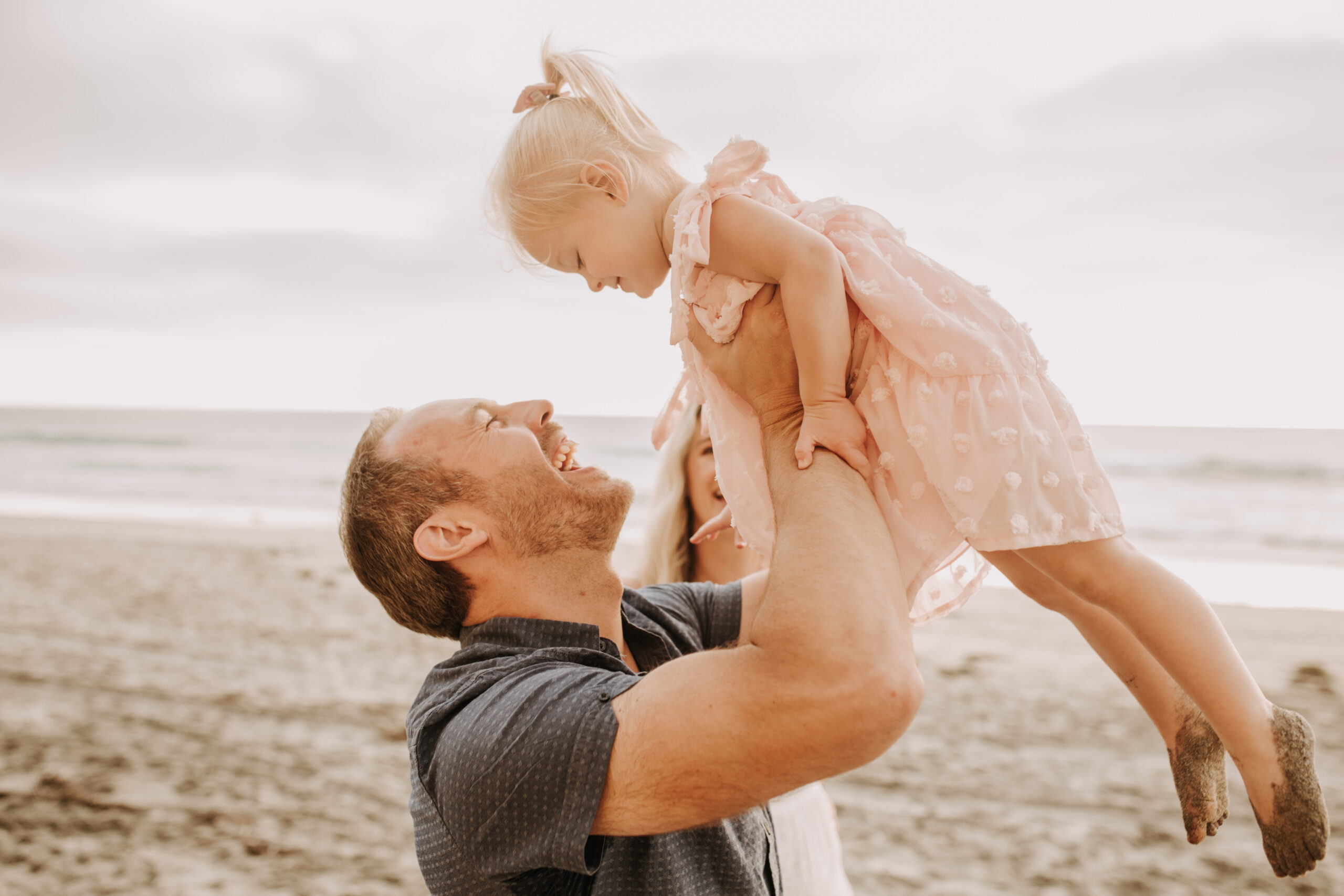 family photos on the beach sunset beach family dad mom baby water golden hour San Diego beach family photos San Diego family photographer