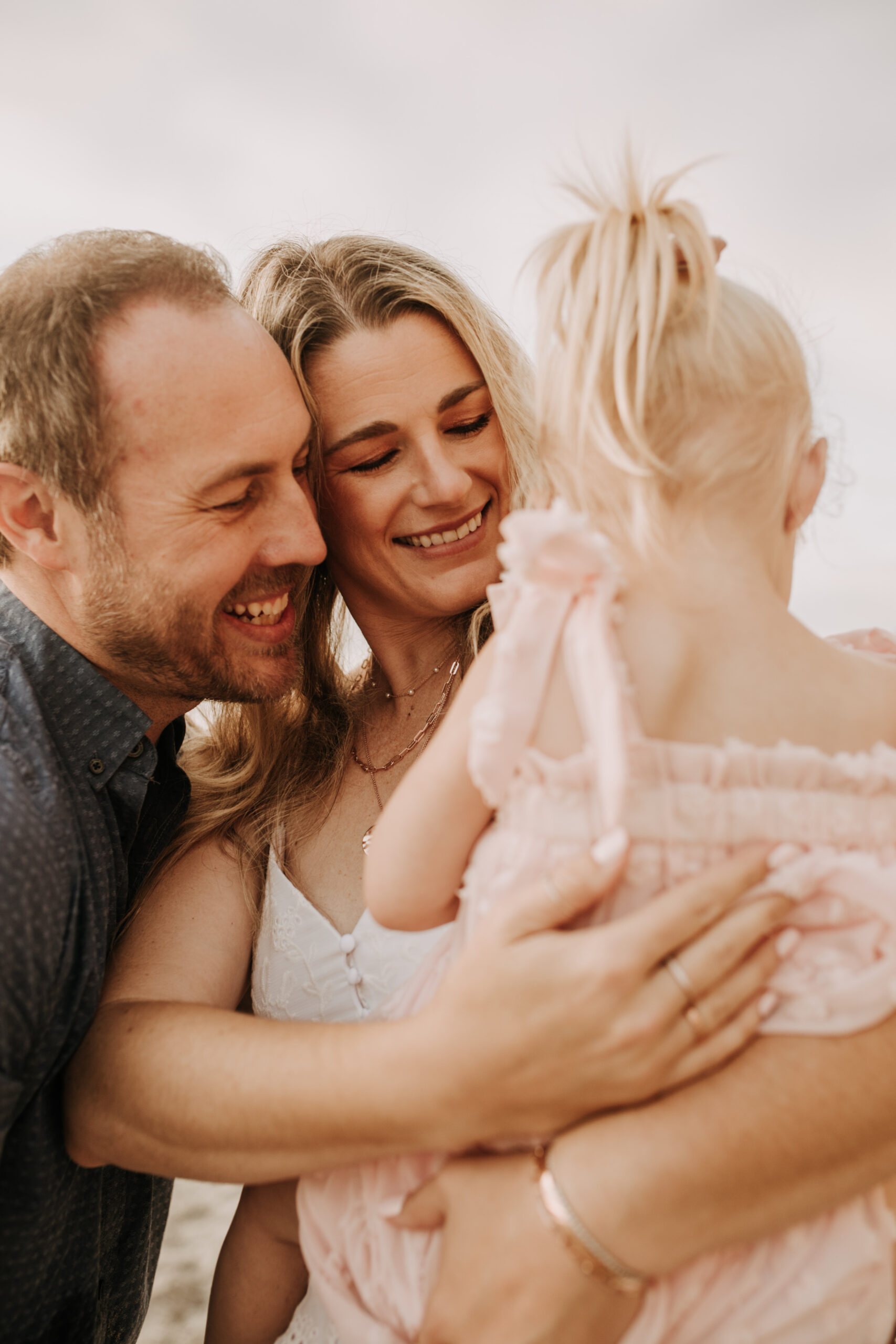 family photos on the beach sunset beach family dad mom baby water golden hour San Diego beach family photos San Diego family photographer