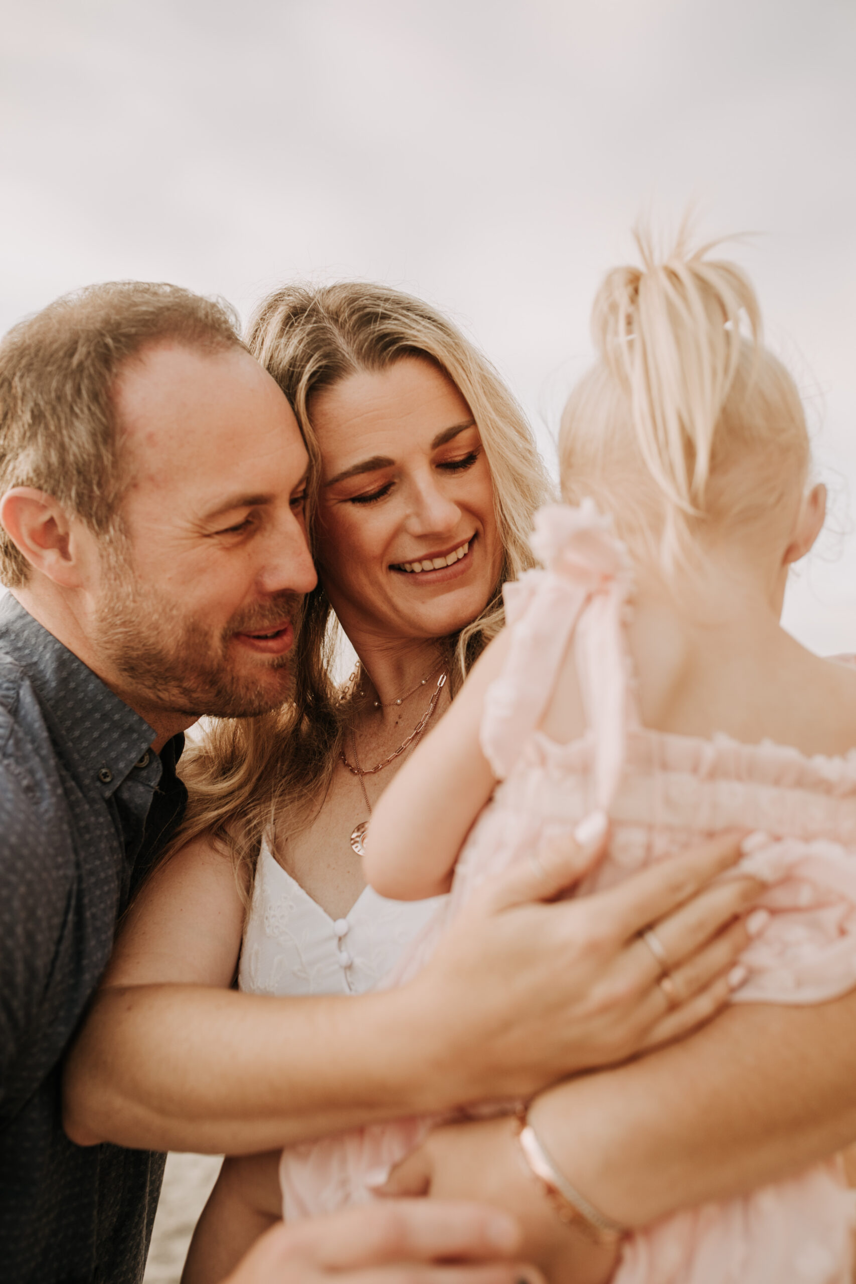 family photos on the beach sunset beach family dad mom baby water golden hour San Diego beach family photos San Diego family photographer