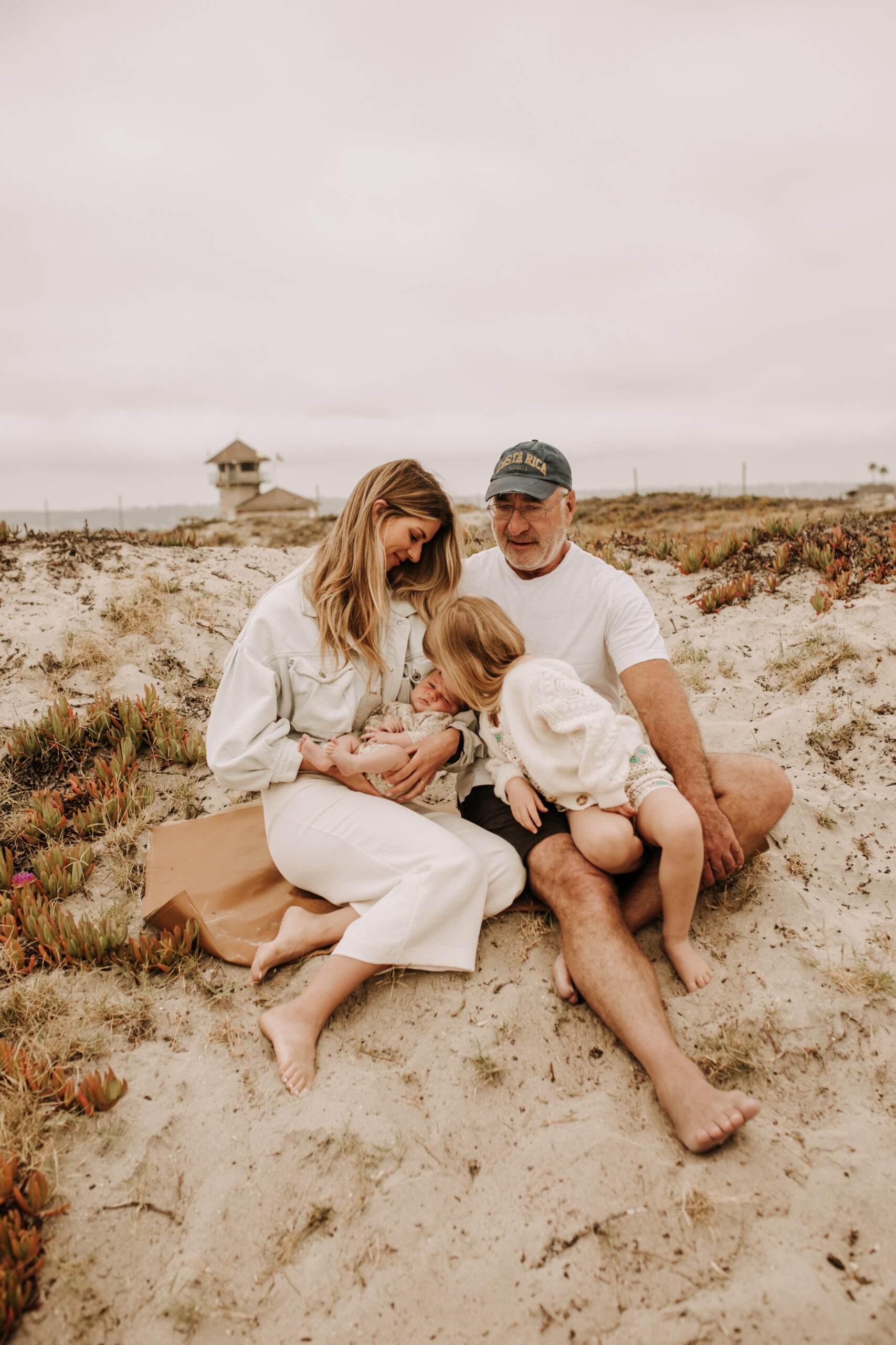 warm toned neutral color outdoor family photos beach day family photos newborn photos infant family cloudy day san digo family photographer Sabrina Kinsella