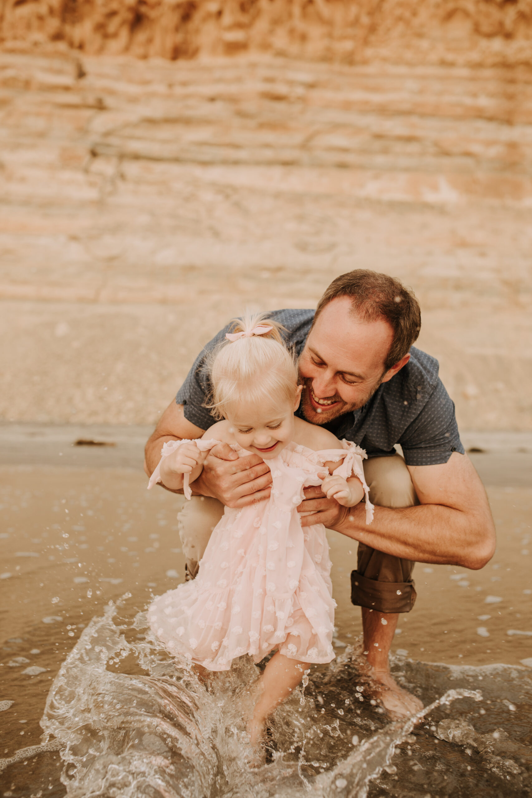 family photos on the beach sunset beach family dad mom baby water golden hour San Diego beach family photos San Diego family photographer