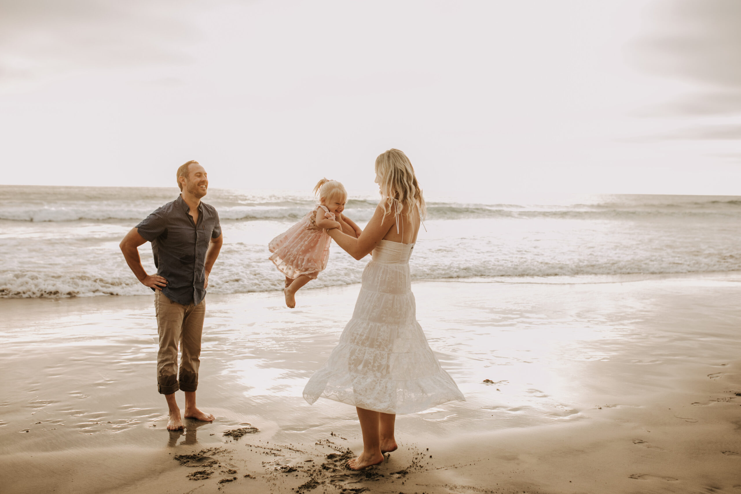 family photos on the beach sunset beach family dad mom baby water golden hour San Diego beach family photos San Diego family photographer