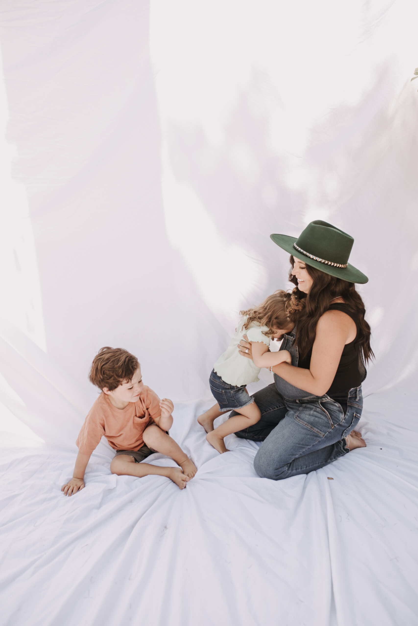 backyard mini session family photos white backdrop outdoor motherhood maternity san diego family photographer